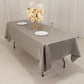 Silver satin tablecloth on a rectangular table with floral arrangement.