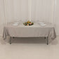 Silver satin rectangle tablecloth on a table with floral centerpiece.