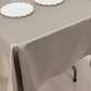 Silver satin rectangle tablecloth on a table with white plates.