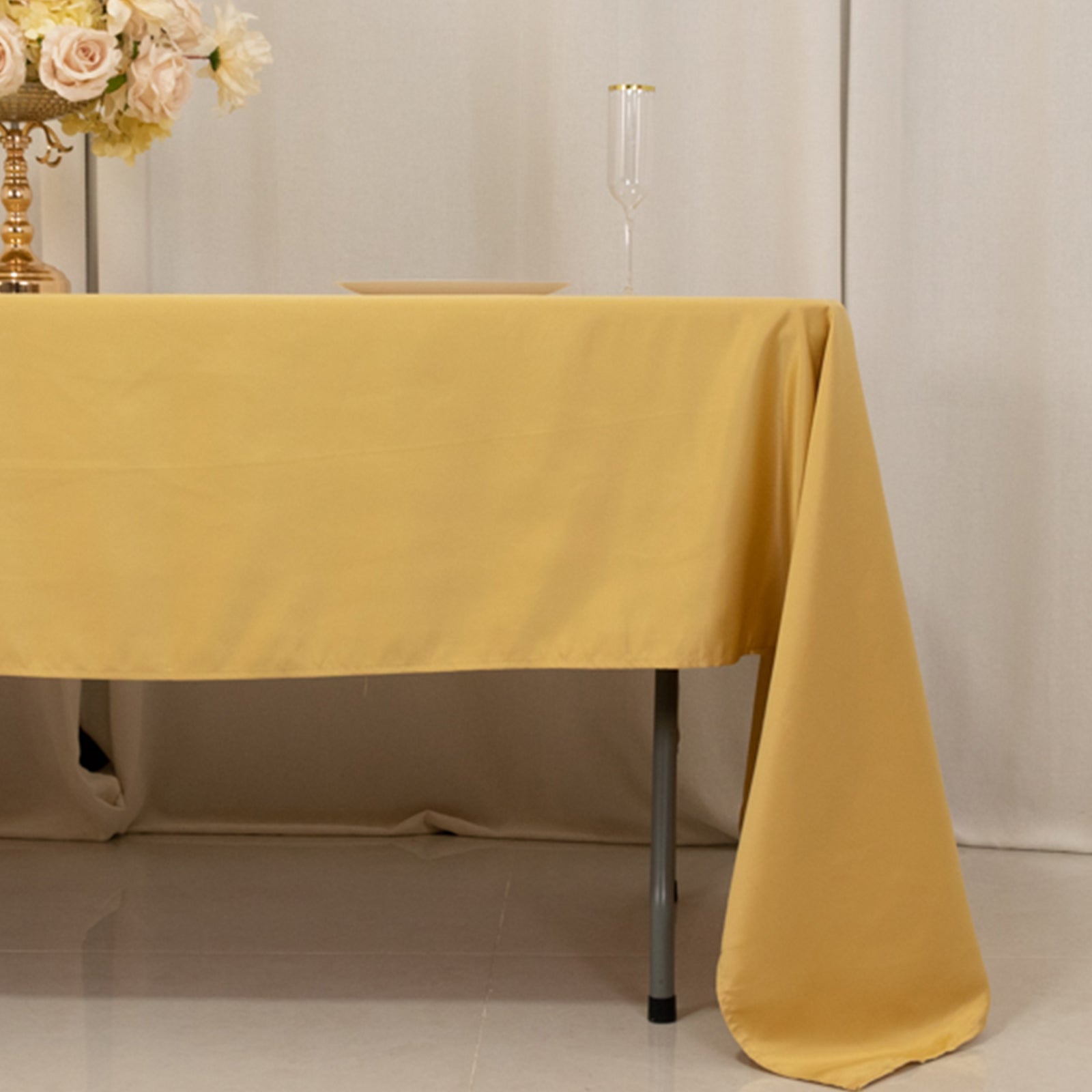 Champagne satin rectangle tablecloth on a table setting.