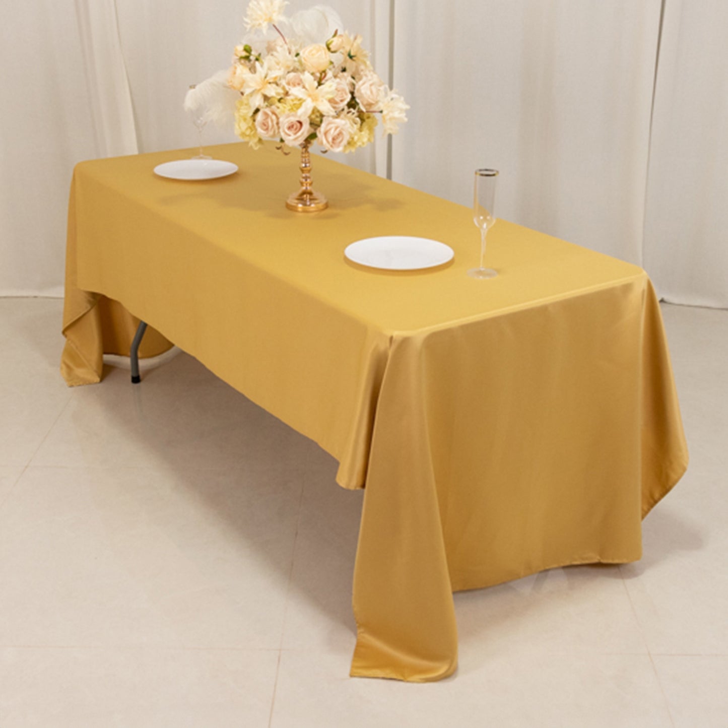 Champagne satin rectangle tablecloth on a dining table.