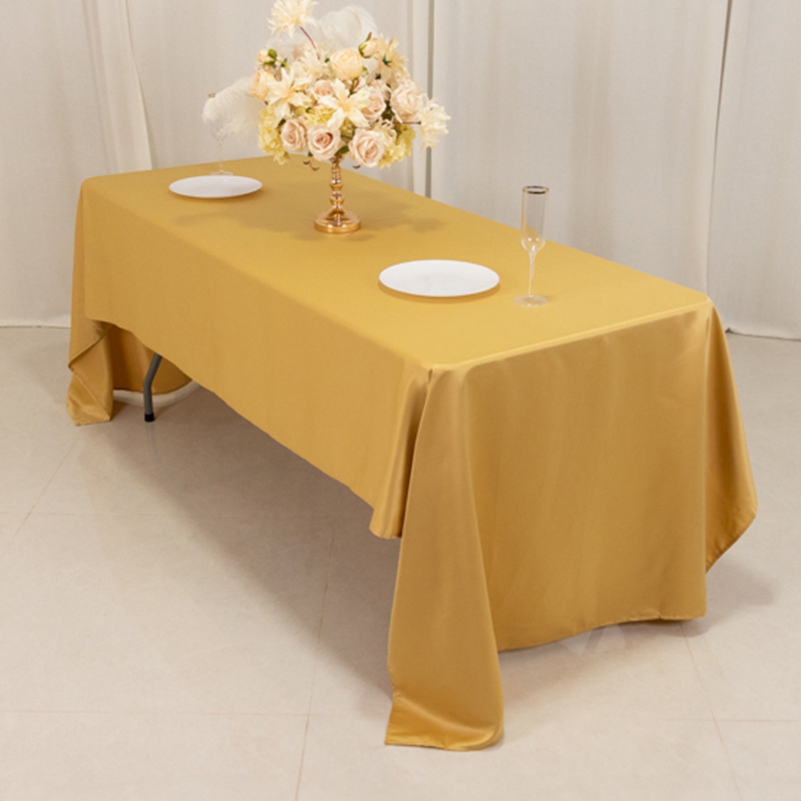 Champagne satin rectangle tablecloth on a dining table.