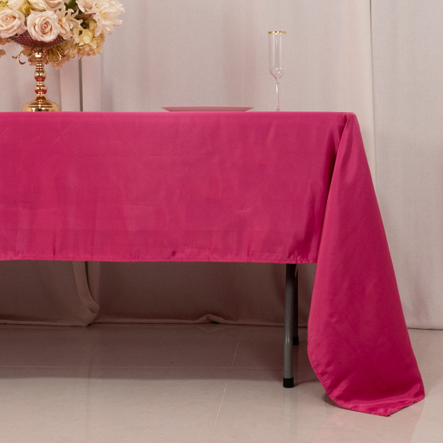 Fuchsia satin rectangle tablecloth on a dining table.