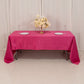 Fuchsia satin rectangle tablecloth on a table with floral centerpiece.
