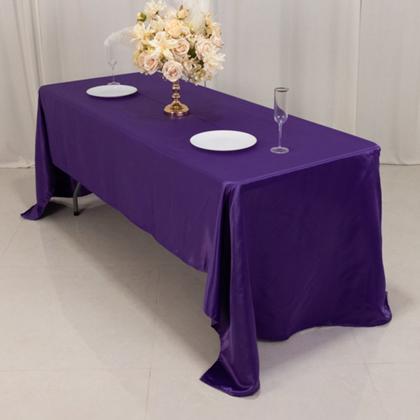 Purple Lamour satin rectangle tablecloth, 60"x126", elegantly draped on a table.