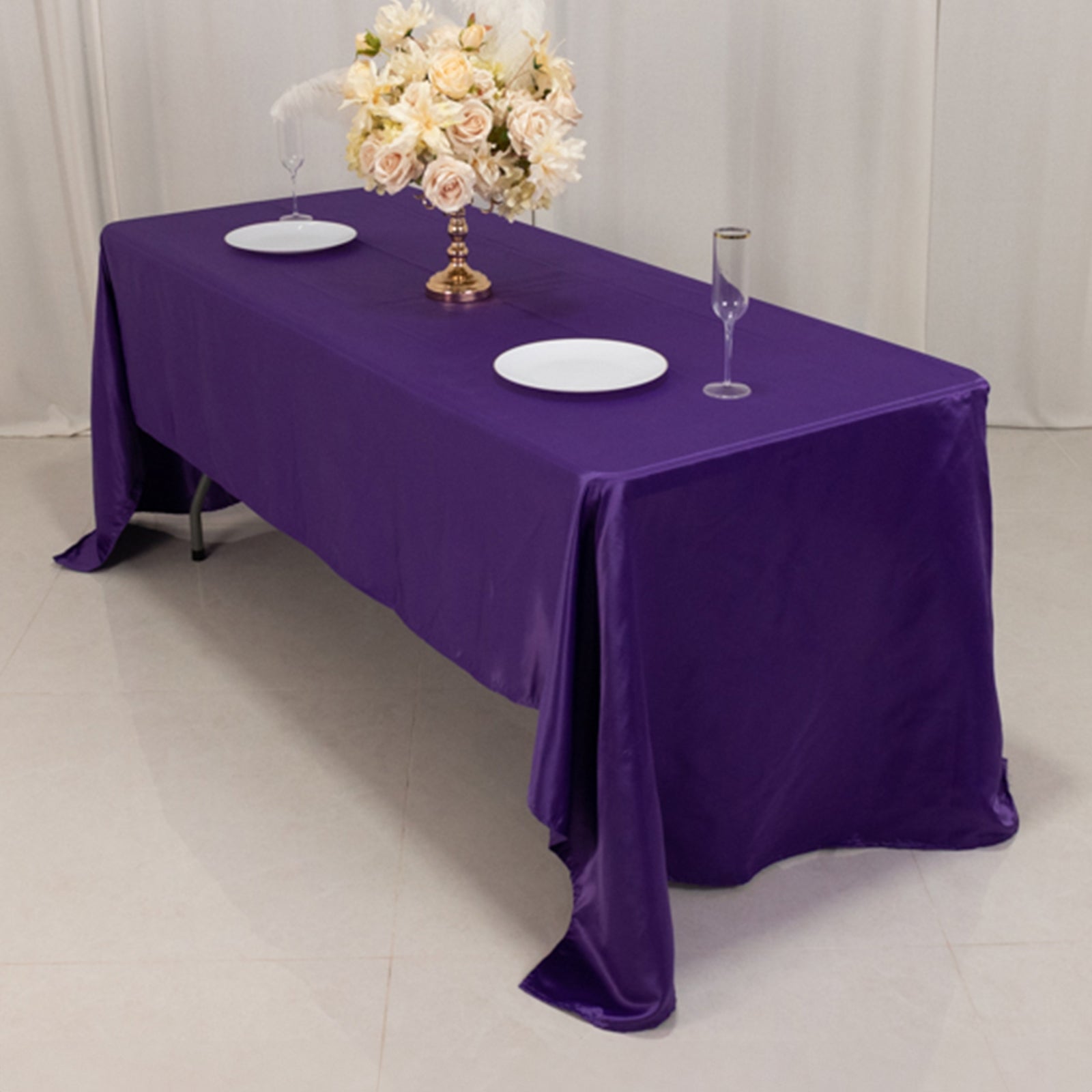 Purple Lamour satin rectangle tablecloth, 60"x126", elegantly draped on a table.
