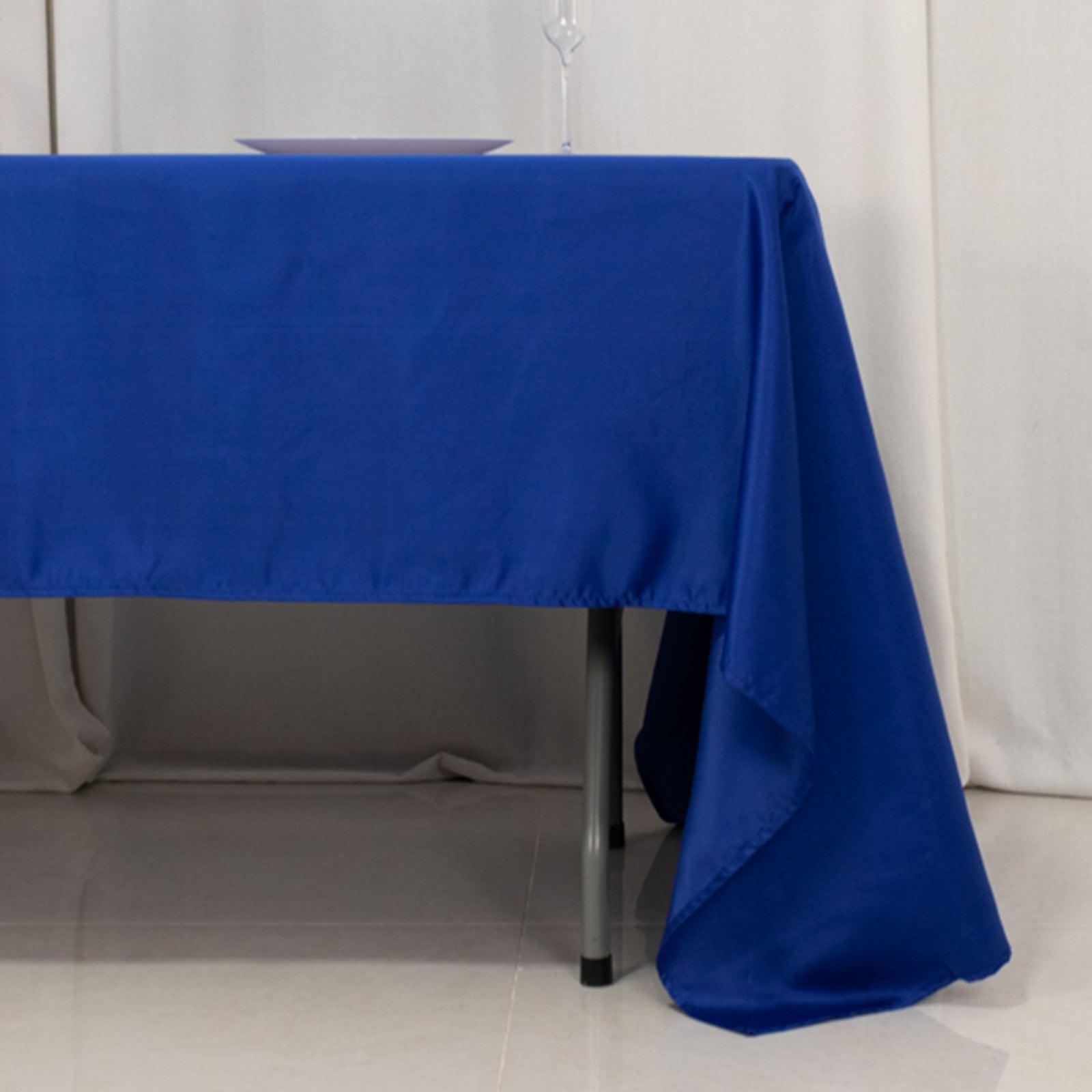 Royal blue satin rectangle tablecloth on a table.
