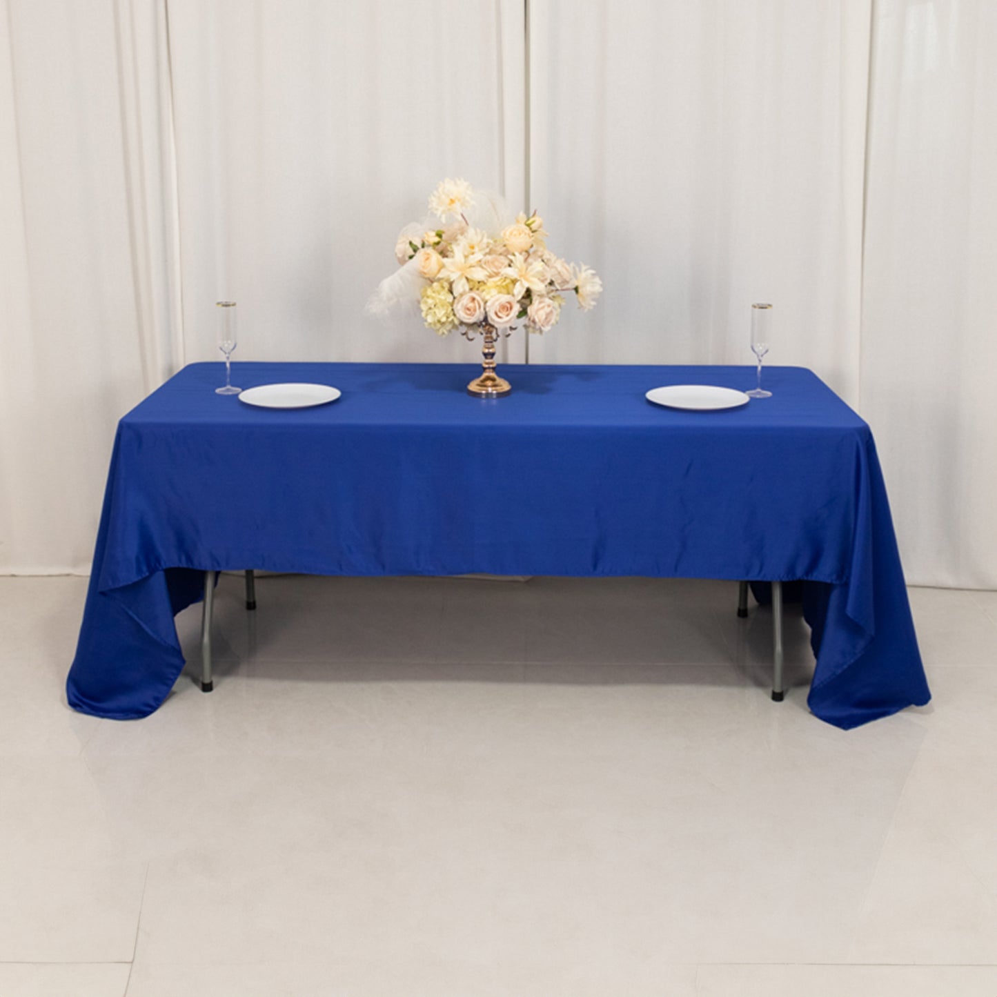 Royal Blue Lamour Satin Rectangle Tablecloth on a table with floral centerpiece.