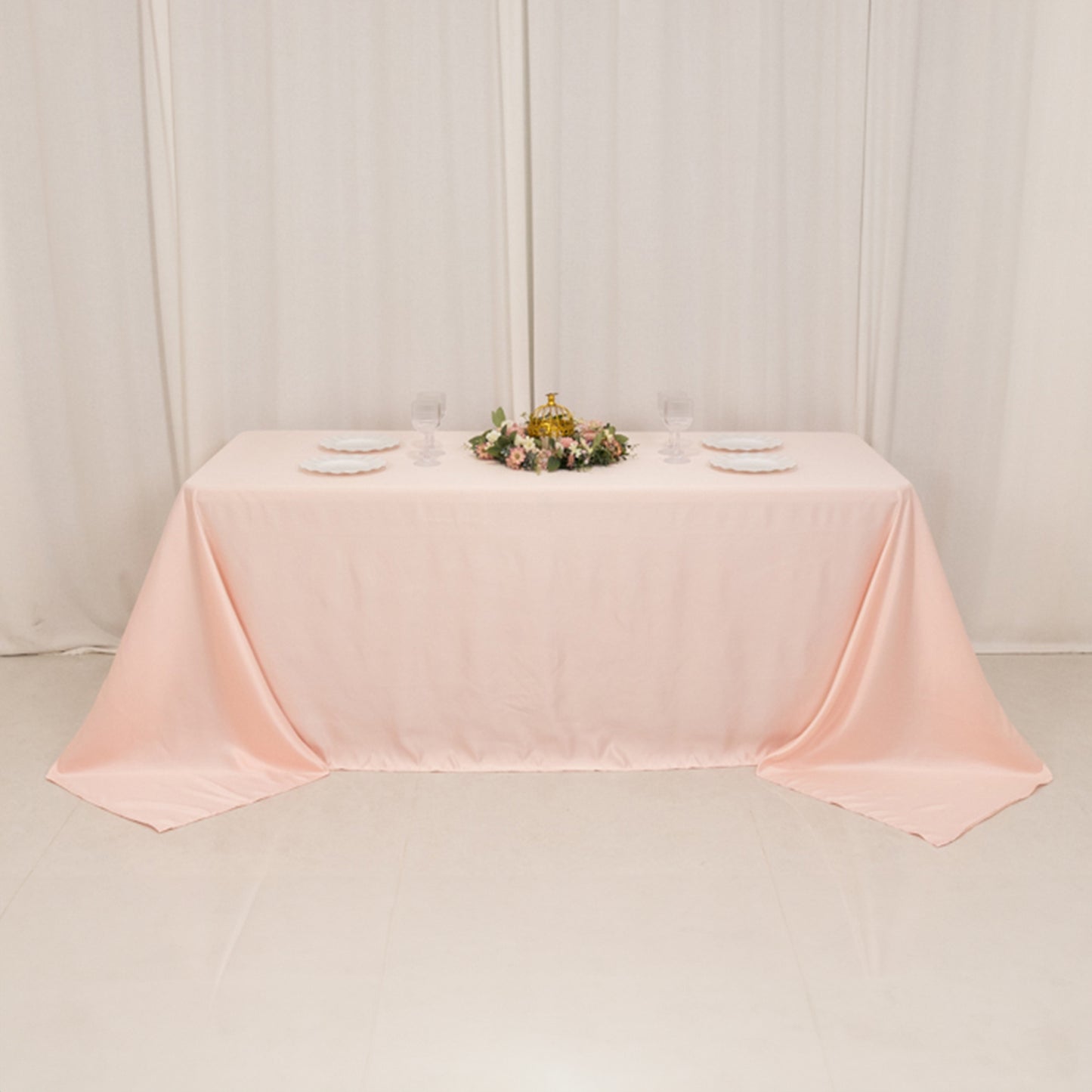Blush satin tablecloth for 6-foot table with floor-length drop.