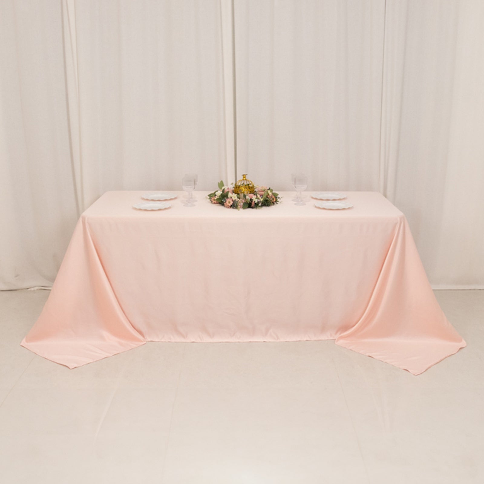 Blush satin tablecloth for 6-foot table with floor-length drop.