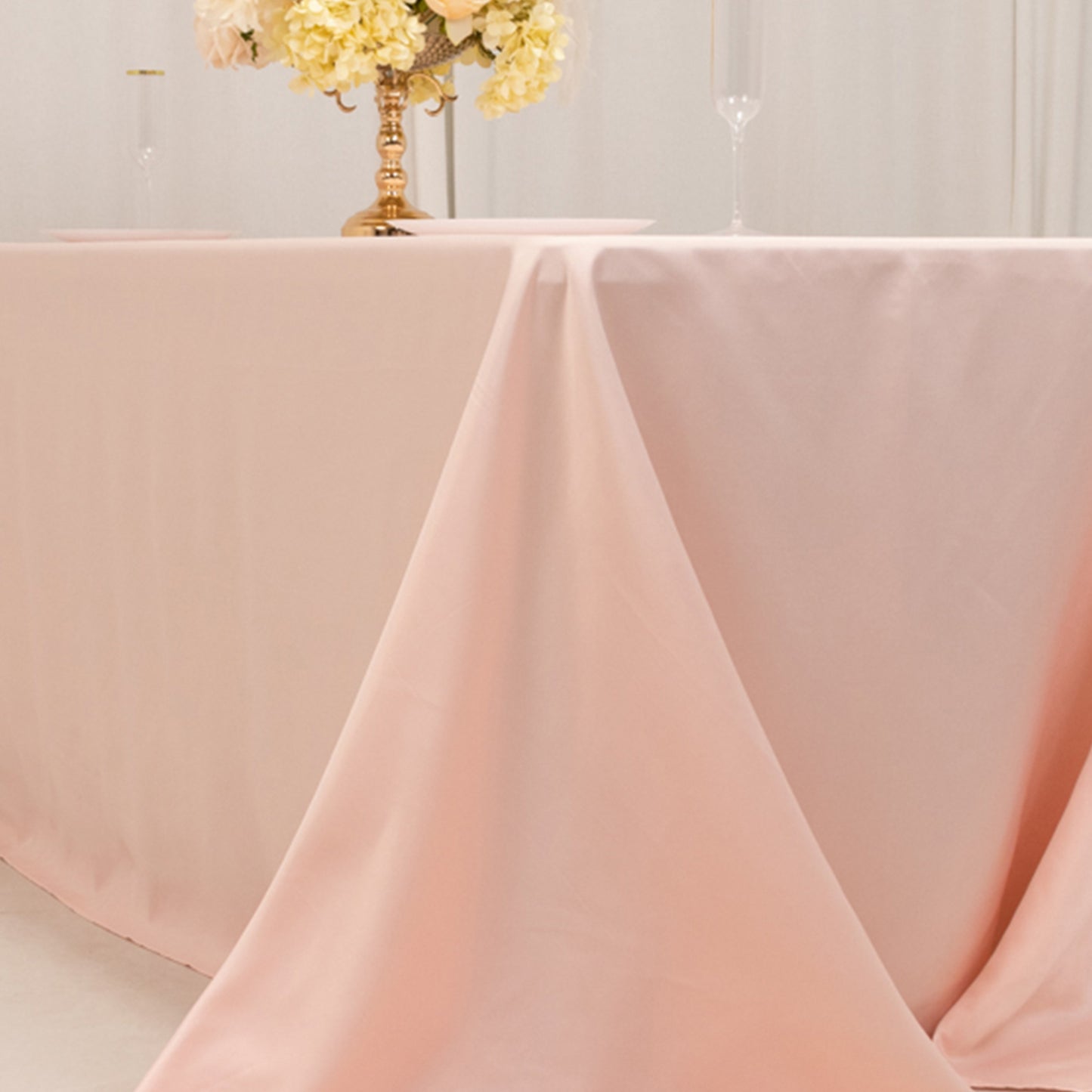 Blush satin rectangle tablecloth for a 6-foot table with floor-length drop.