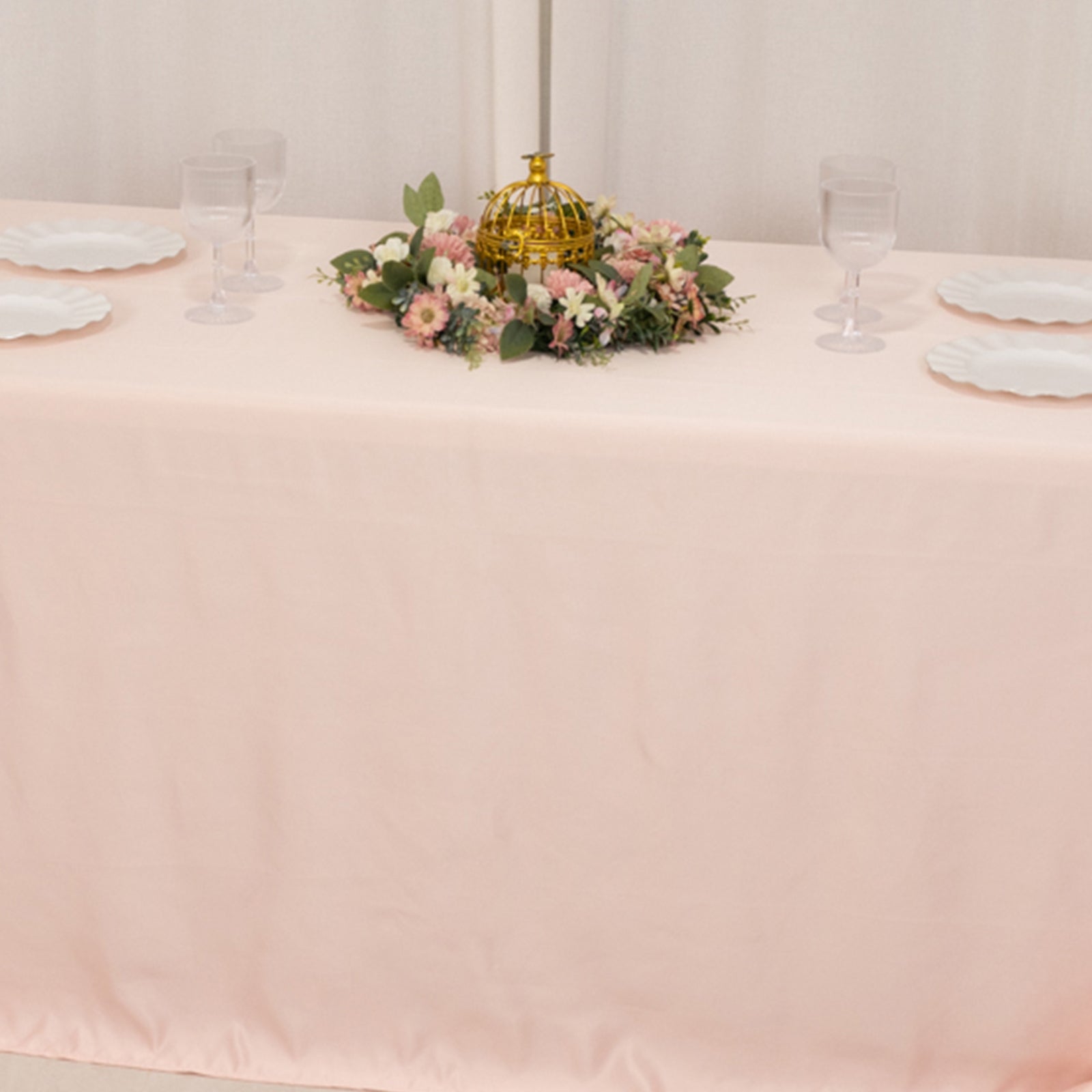 Blush satin tablecloth for 6-foot table with floor-length drop.