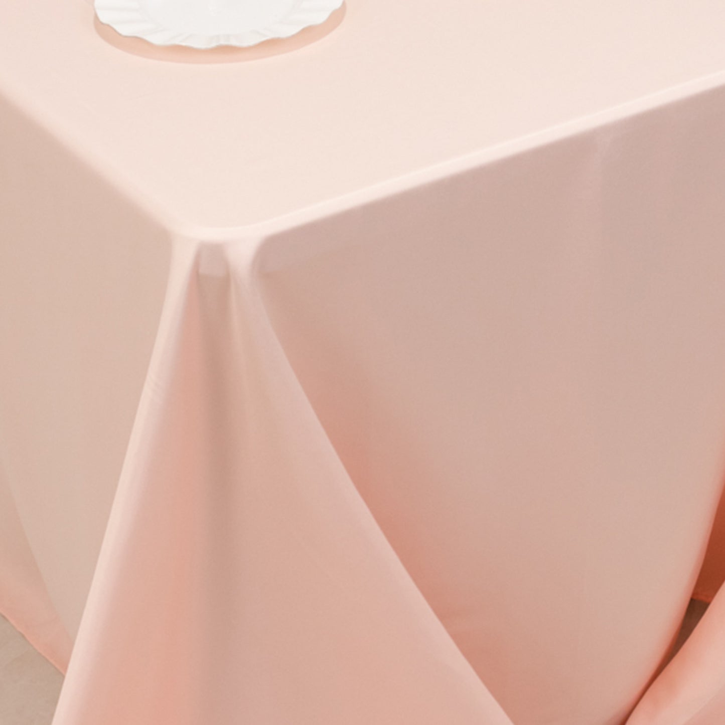 Blush satin tablecloth for 6 foot table with floor-length drop.