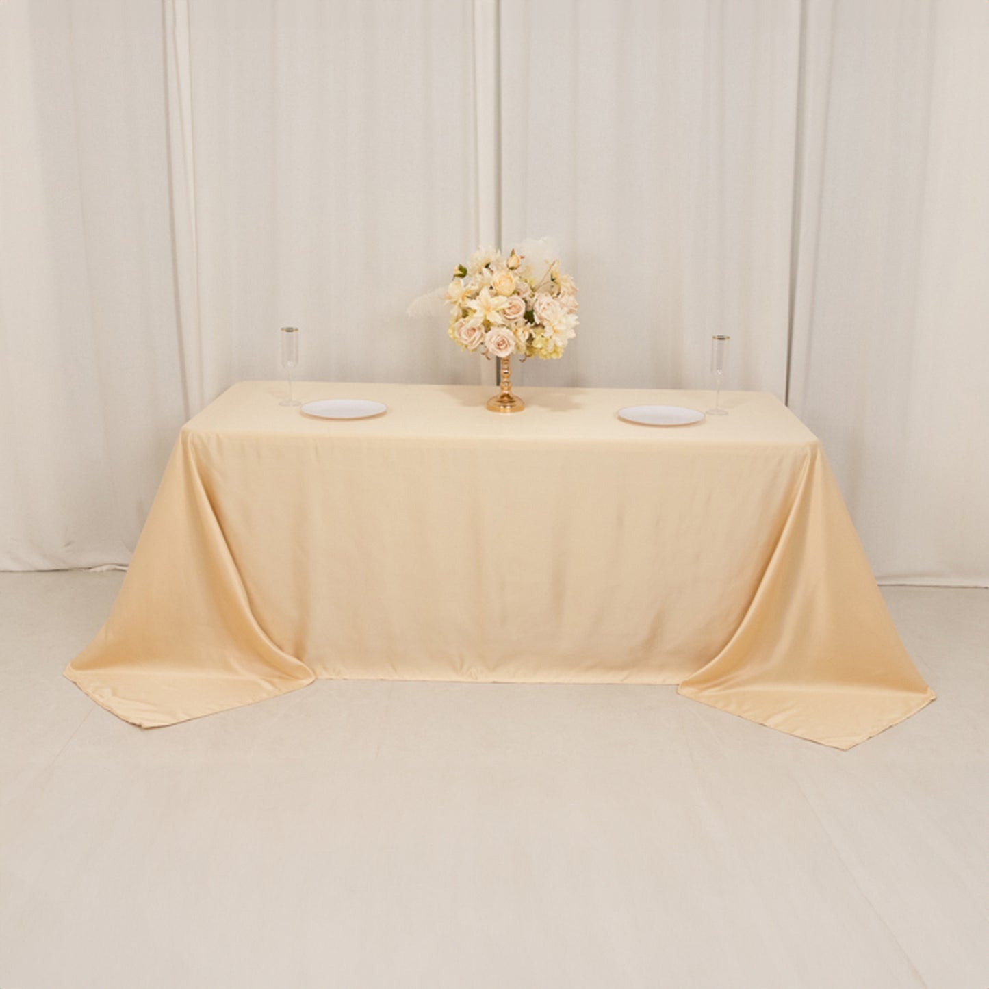 Beige seamless satin tablecloth for 6-foot table with floor-length drop.