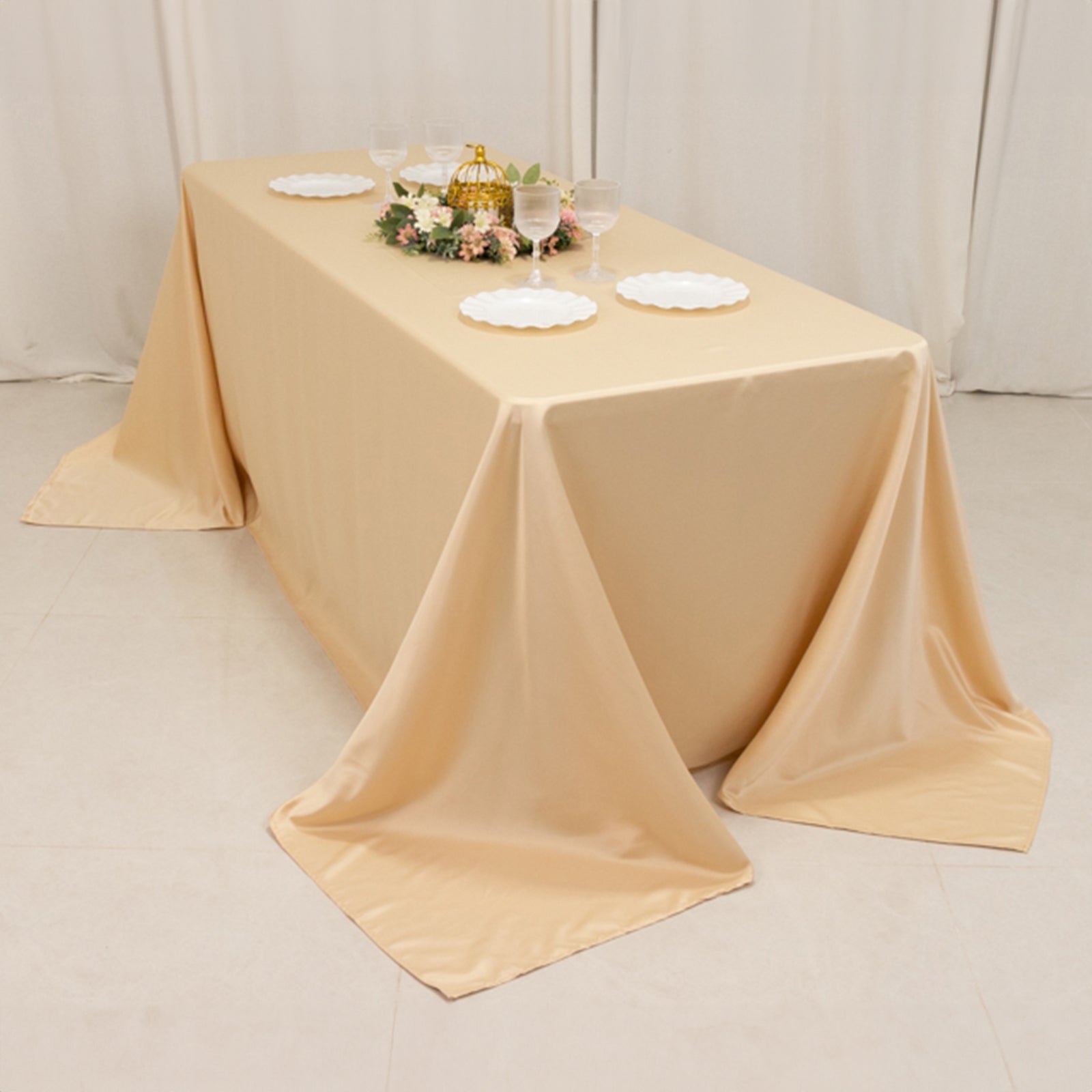 Beige seamless satin tablecloth for 6-foot table with floor-length drop.