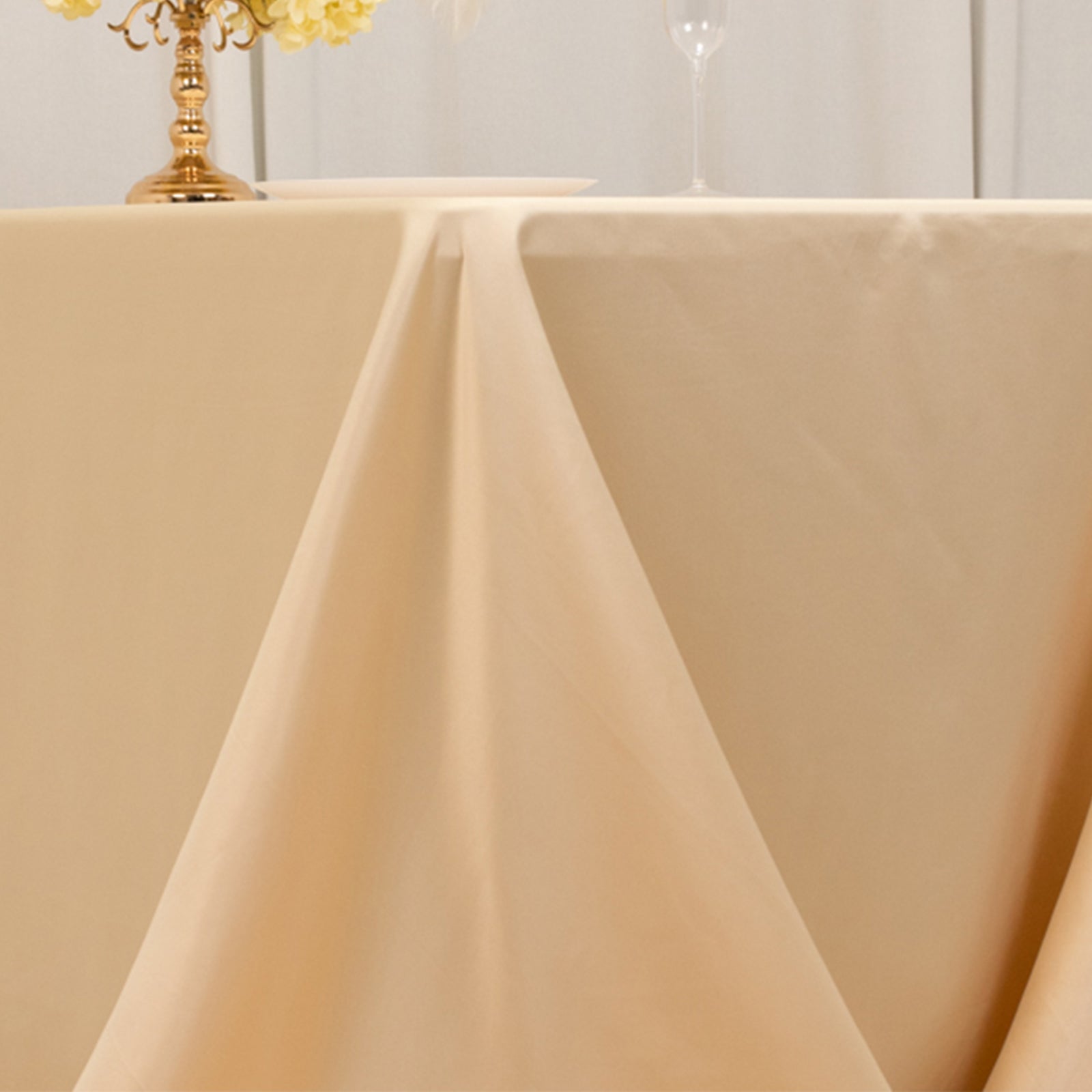 Beige seamless satin tablecloth for 6-foot table with floor-length drop.