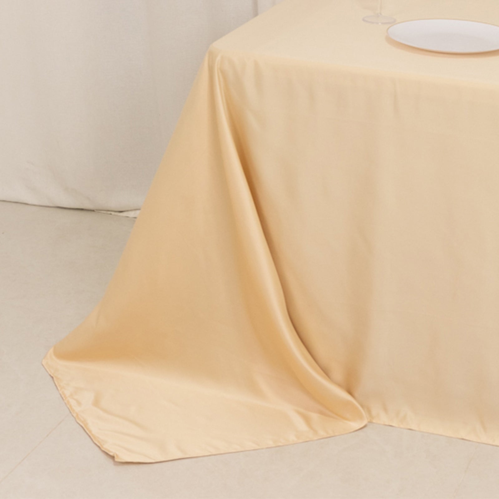 Beige satin tablecloth draped elegantly over a 6-foot table.