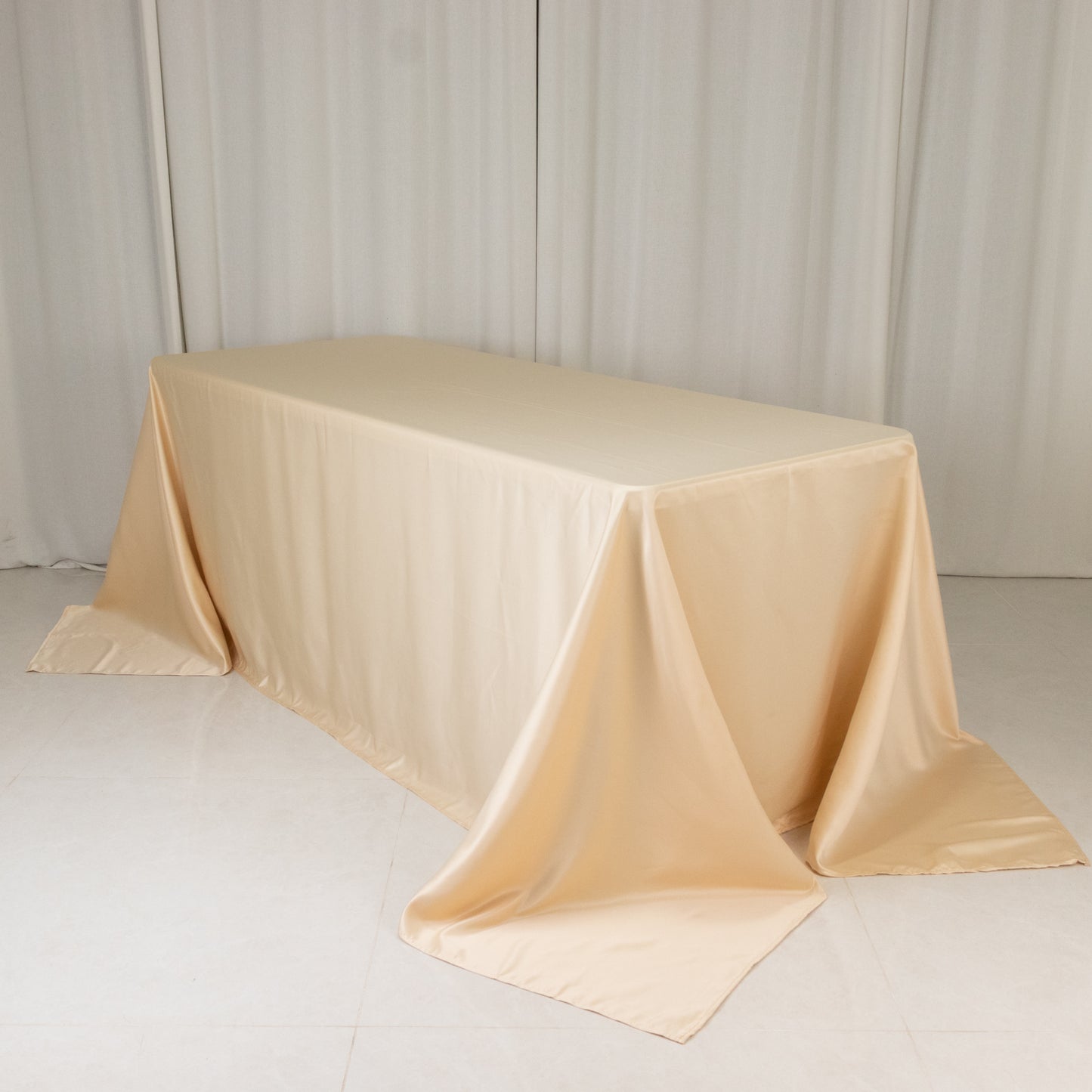 Beige seamless satin tablecloth for a 6-foot table with floor-length drop.