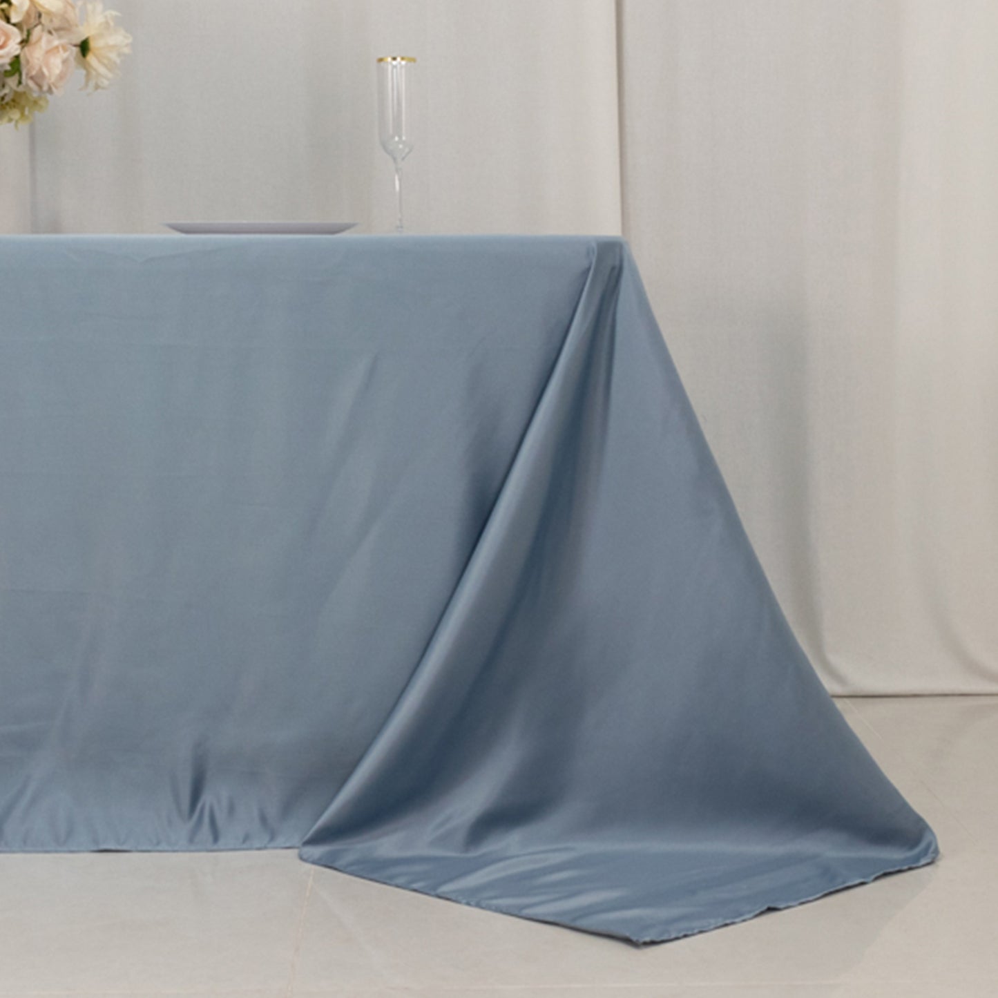 Dusty blue satin tablecloth for 6-foot table with floor-length drop.