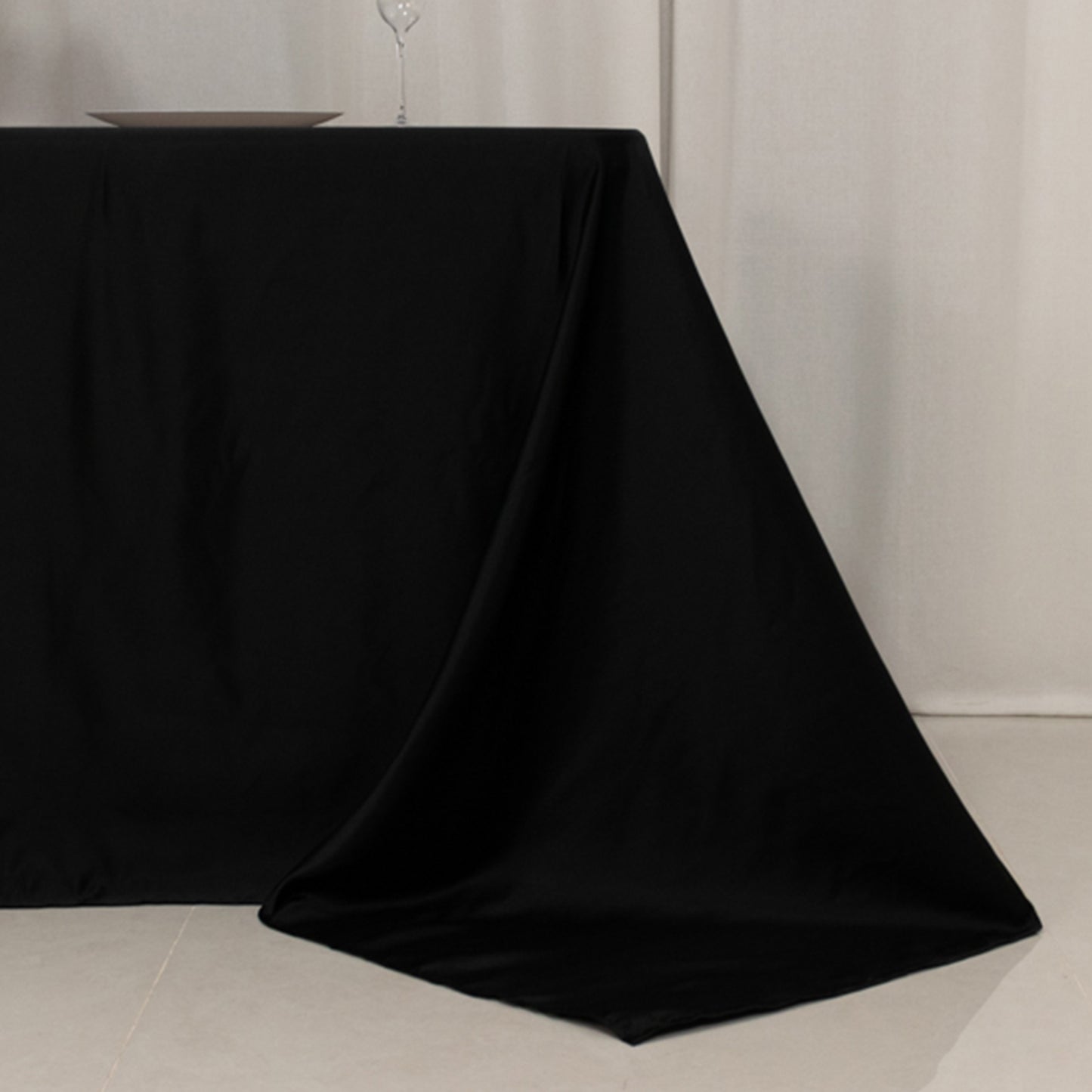 Black satin tablecloth for 6 foot table with floor-length drop.