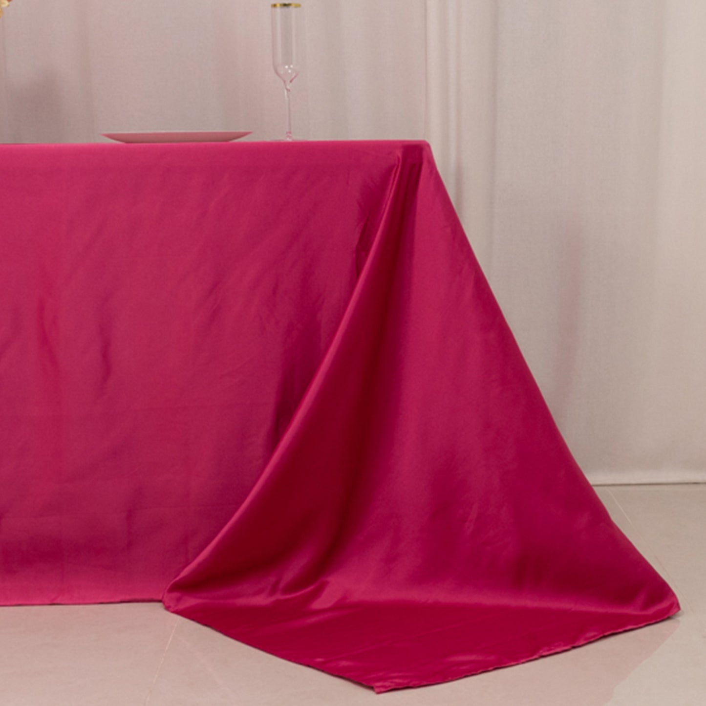 Fuchsia satin tablecloth for 6-foot table with floor-length drop.