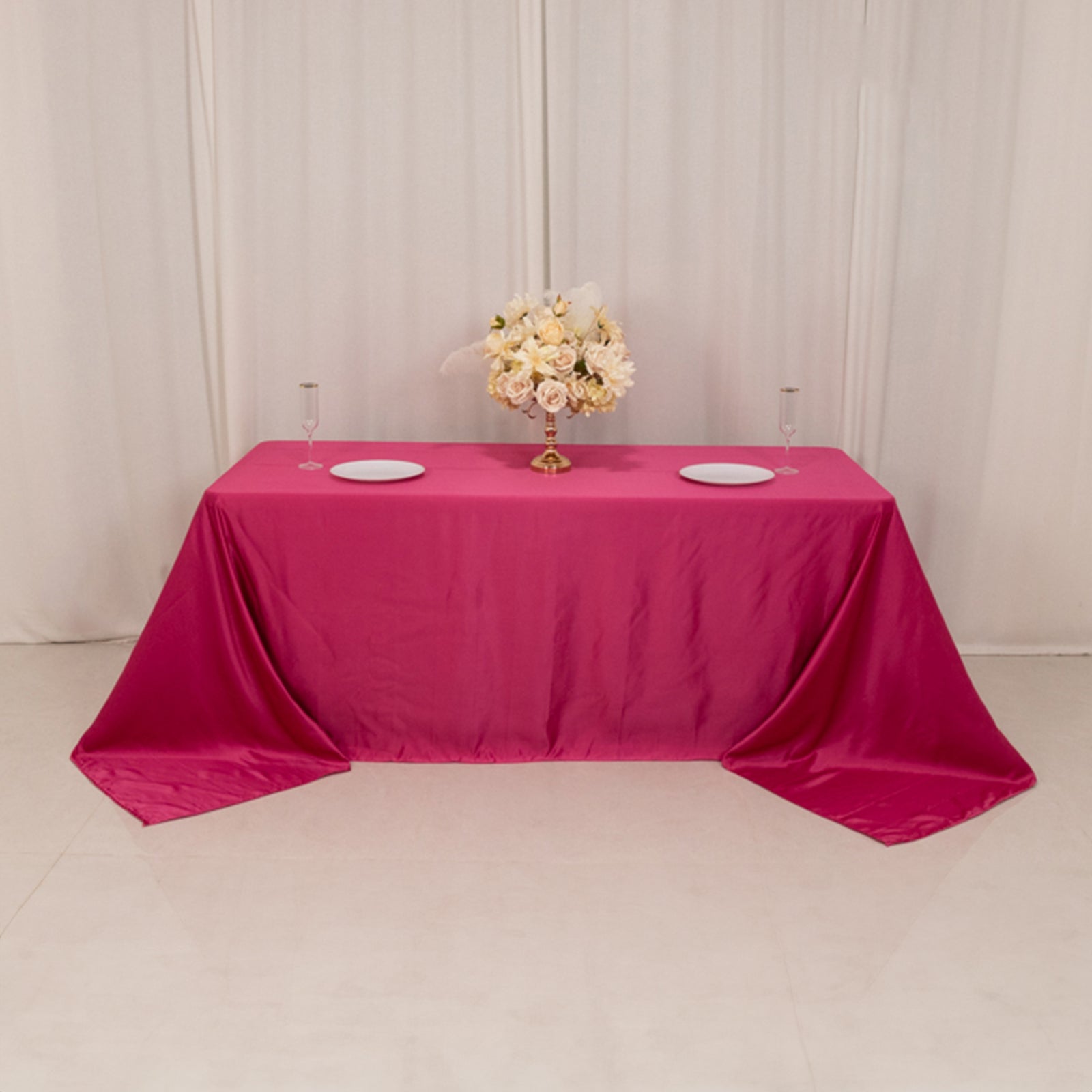 Fuchsia satin tablecloth for a 6-foot table with floor-length drop.