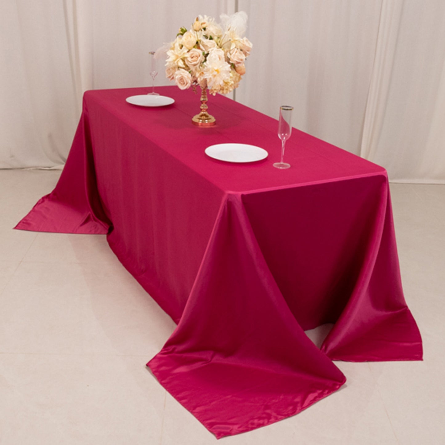 Fuchsia satin rectangle tablecloth for a 6-foot table with floor-length drop.