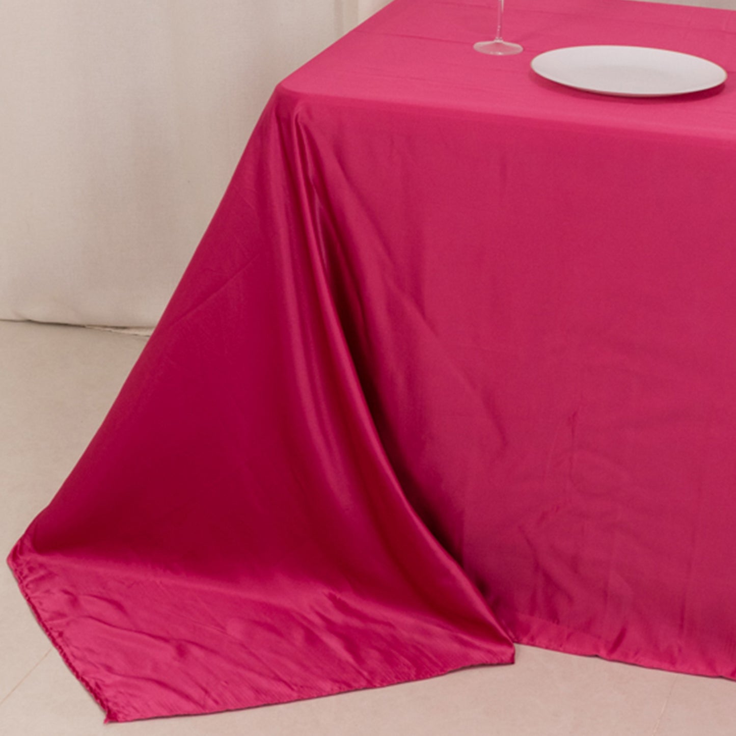 Fuchsia satin tablecloth for a 6-foot table with floor-length drop.