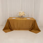 Gold satin tablecloth draped elegantly on a 6-foot table.