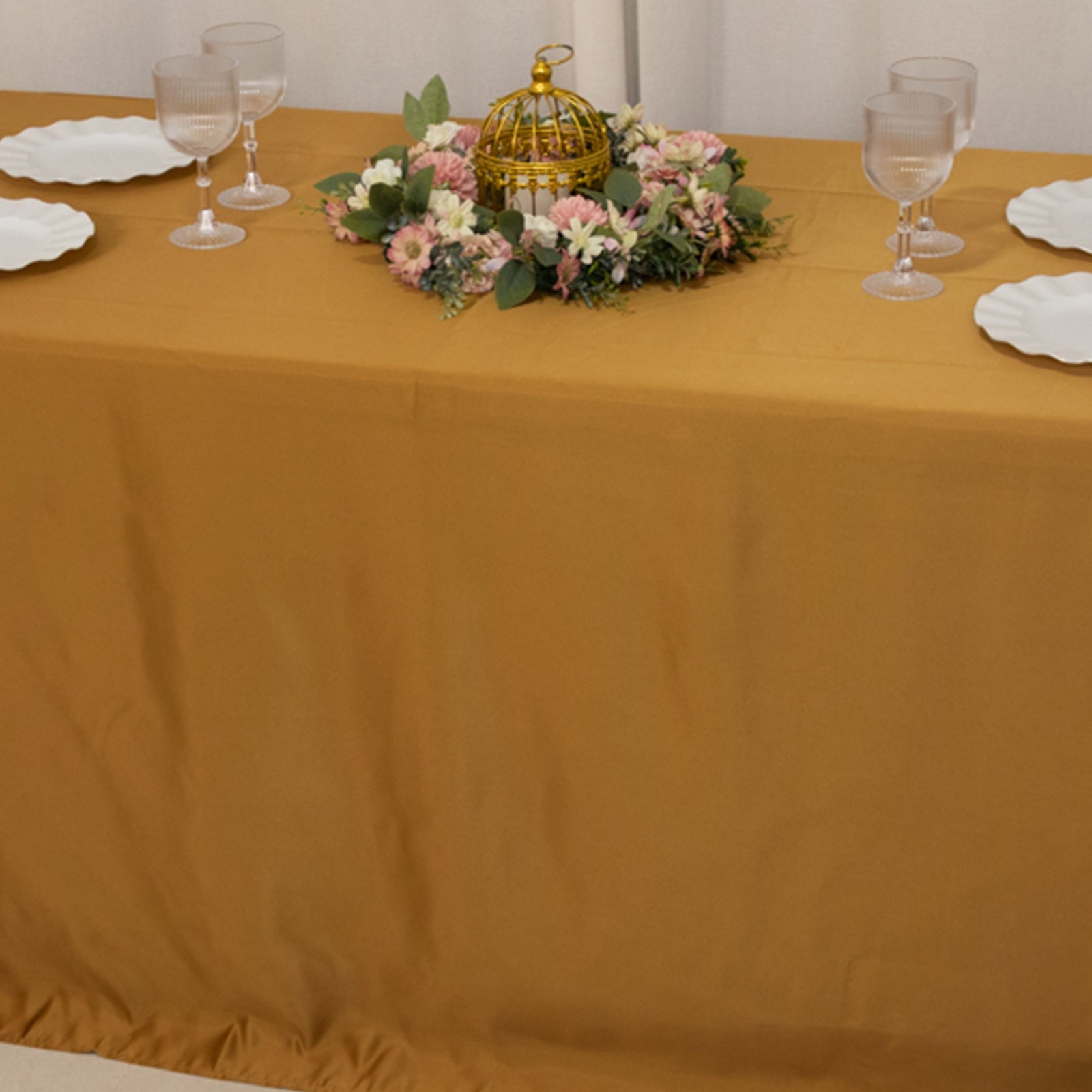 Gold seamless satin tablecloth for a 6-foot table with floor-length drop.