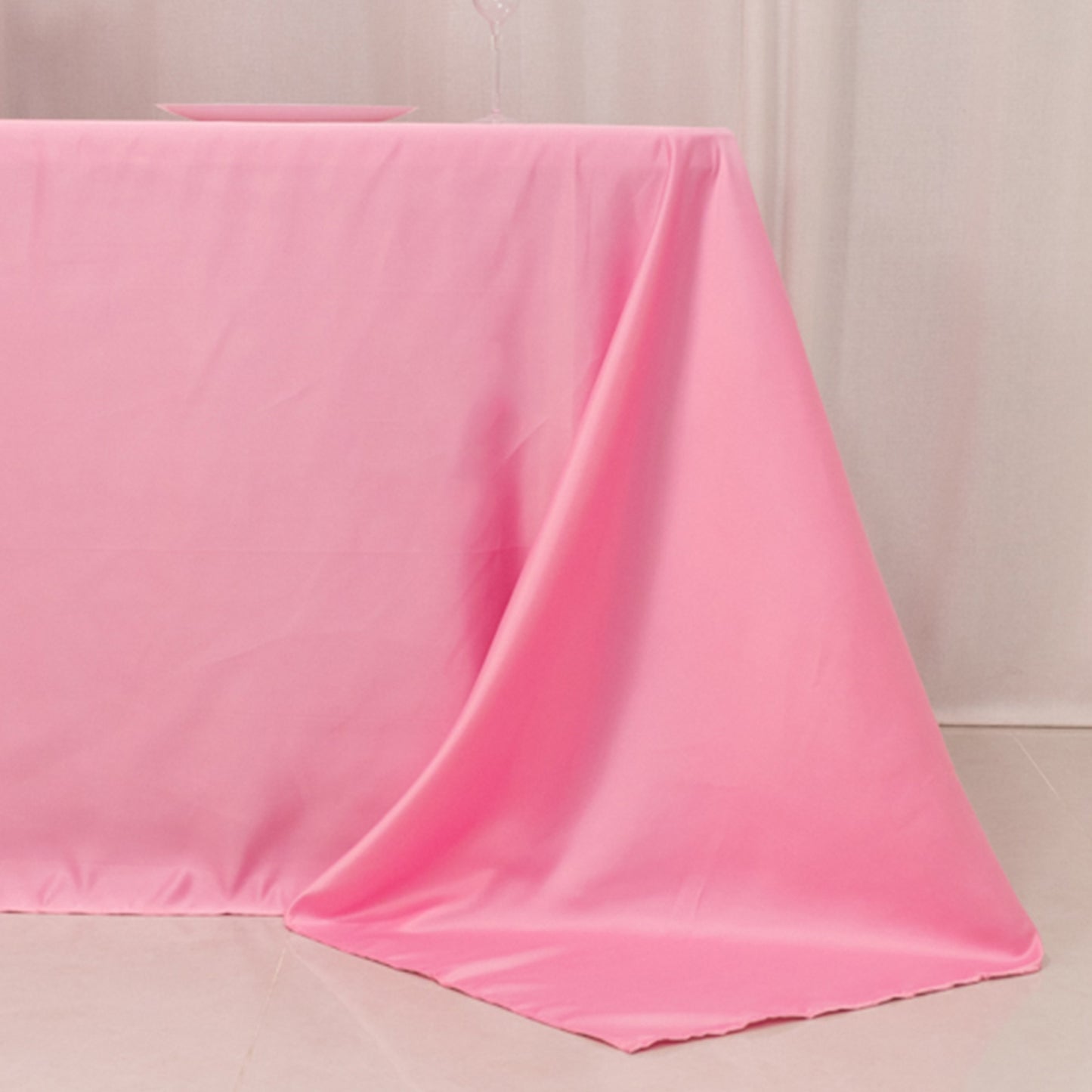 Pink satin tablecloth for 6-foot table with floor-length drop.