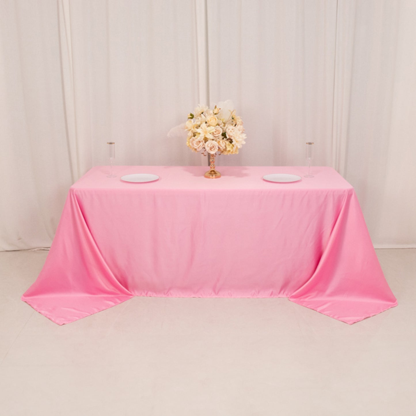 Pink satin tablecloth for 6 foot table with floor-length drop.