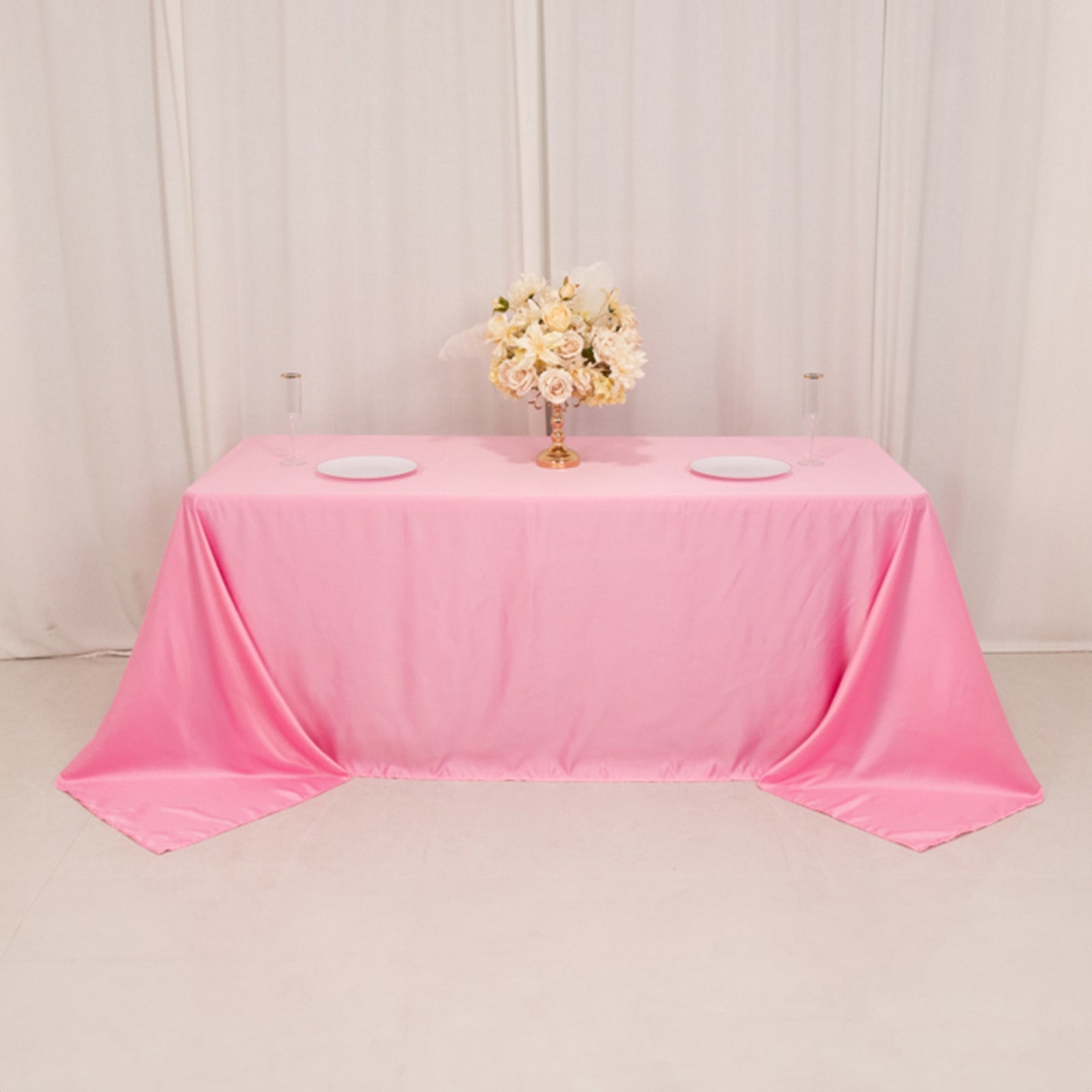 Pink satin tablecloth for 6 foot table with floor-length drop.