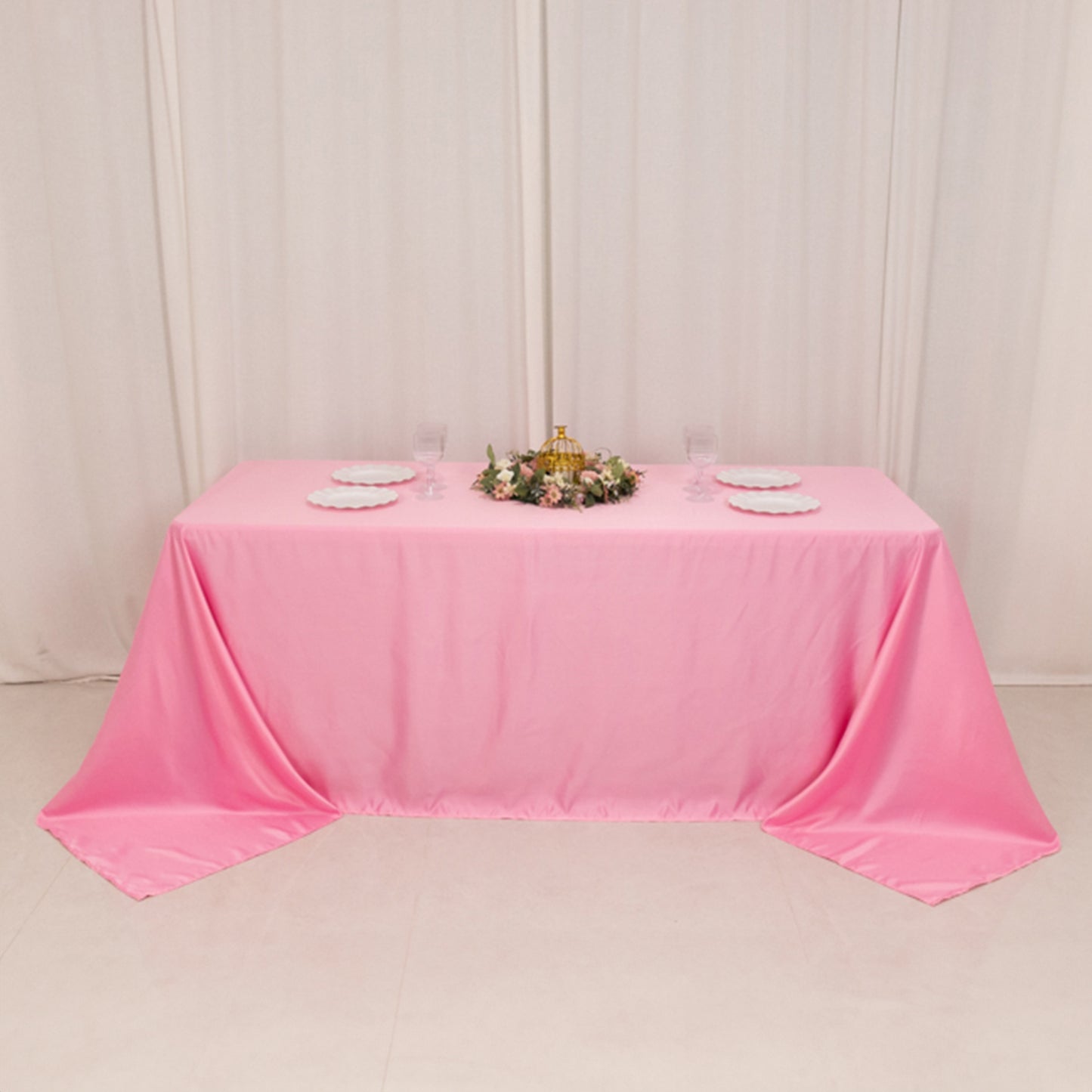 90"x132" pink satin tablecloth for 6 foot table with floor-length drop.