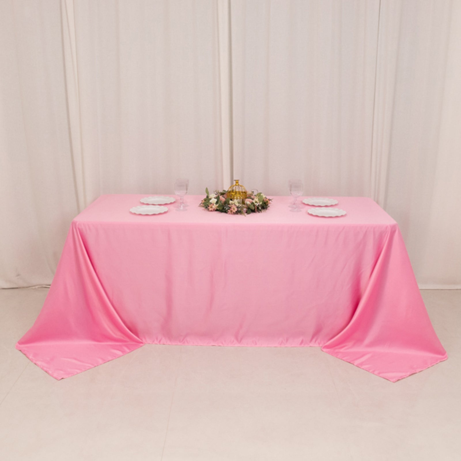 90"x132" pink satin tablecloth for 6 foot table with floor-length drop.