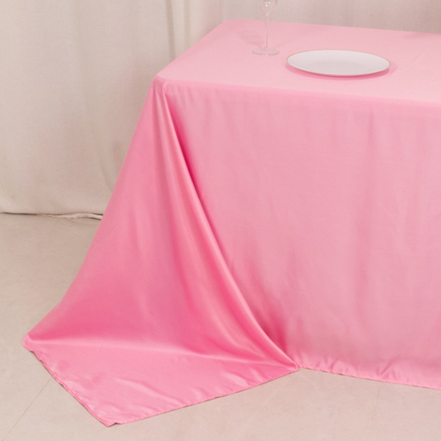 90"x132" pink satin tablecloth for 6-foot table, floor-length drop.