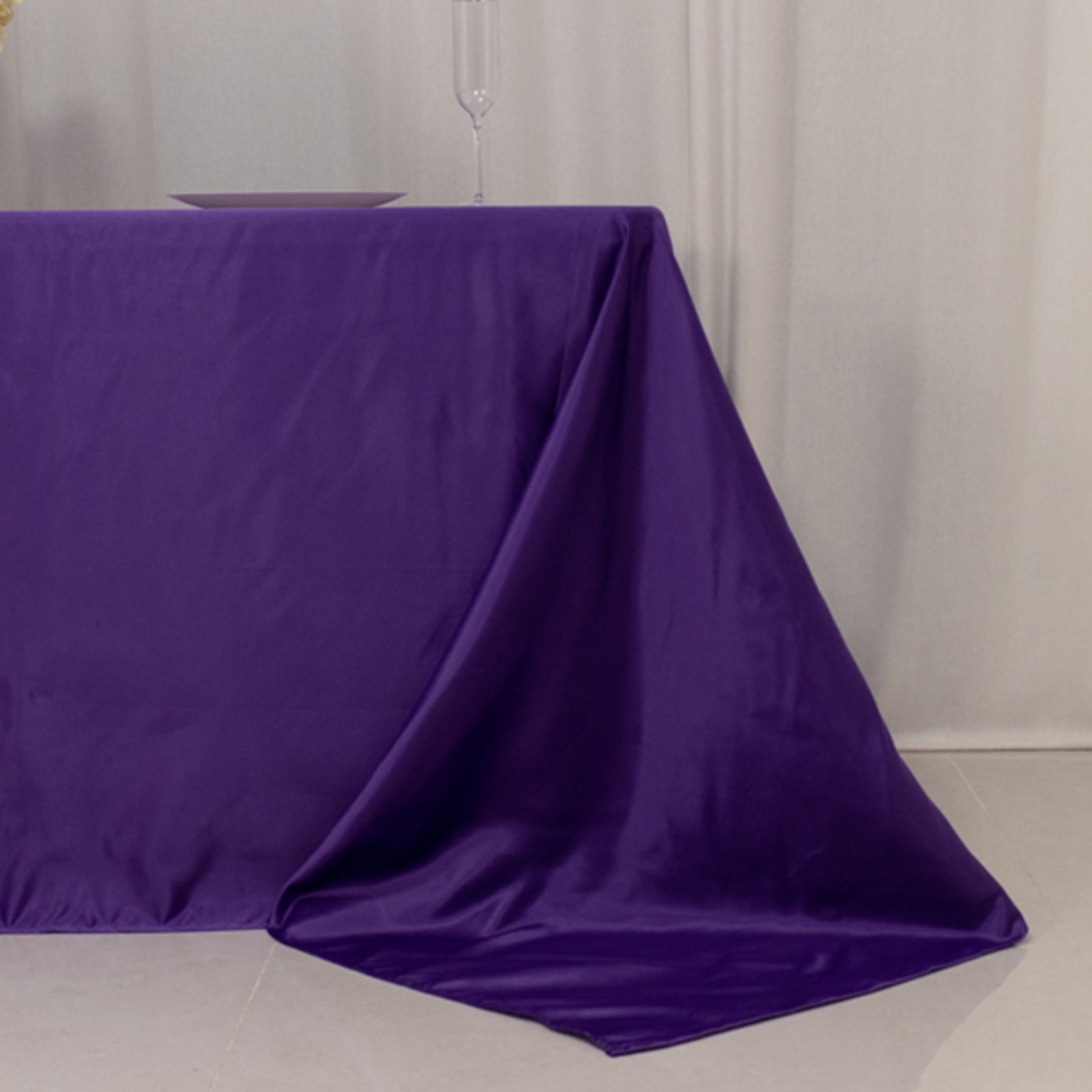 Purple seamless satin tablecloth draping elegantly on a 6-foot table.