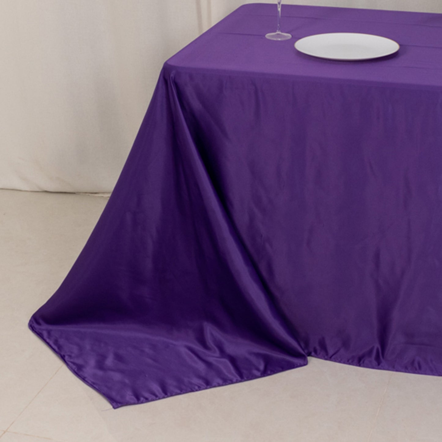 Purple seamless satin tablecloth for 6-foot table with floor-length drop.
