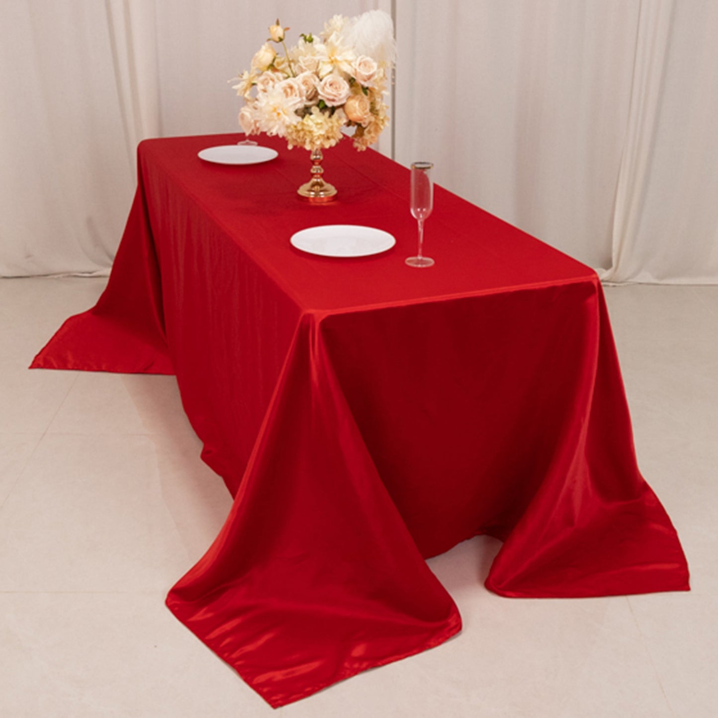Red seamless satin tablecloth draping elegantly over a 6-foot table.
