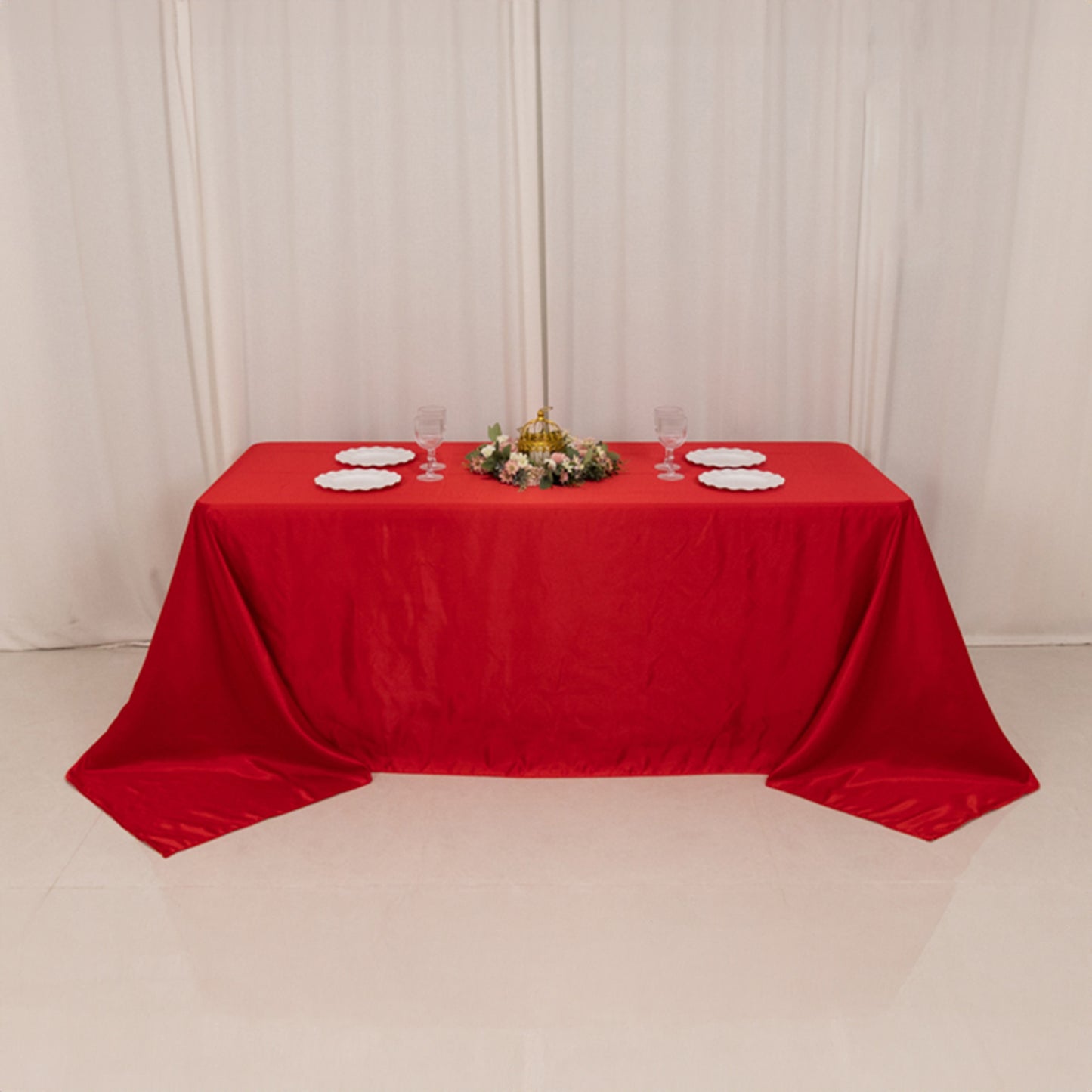 Red seamless satin tablecloth for a 6-foot table with floor-length drop.