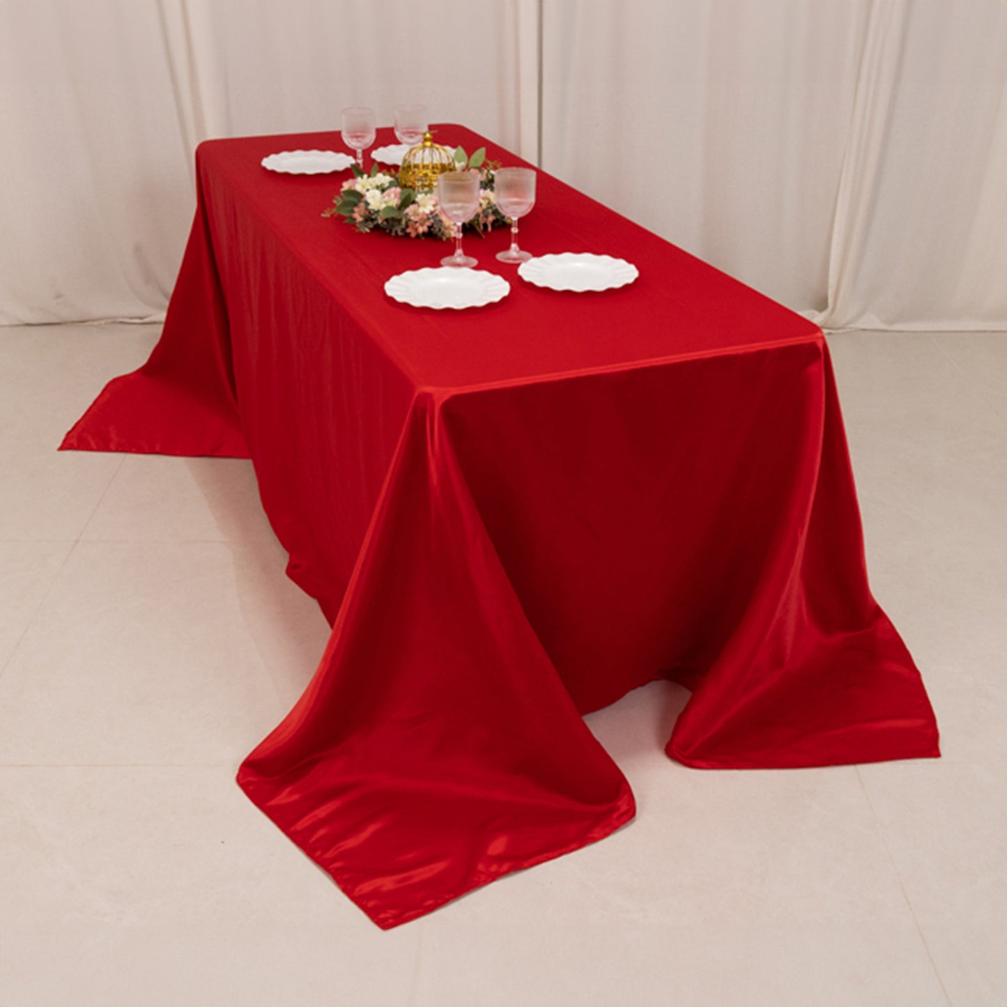 Red satin tablecloth on a 6-foot table with floor-length drop.