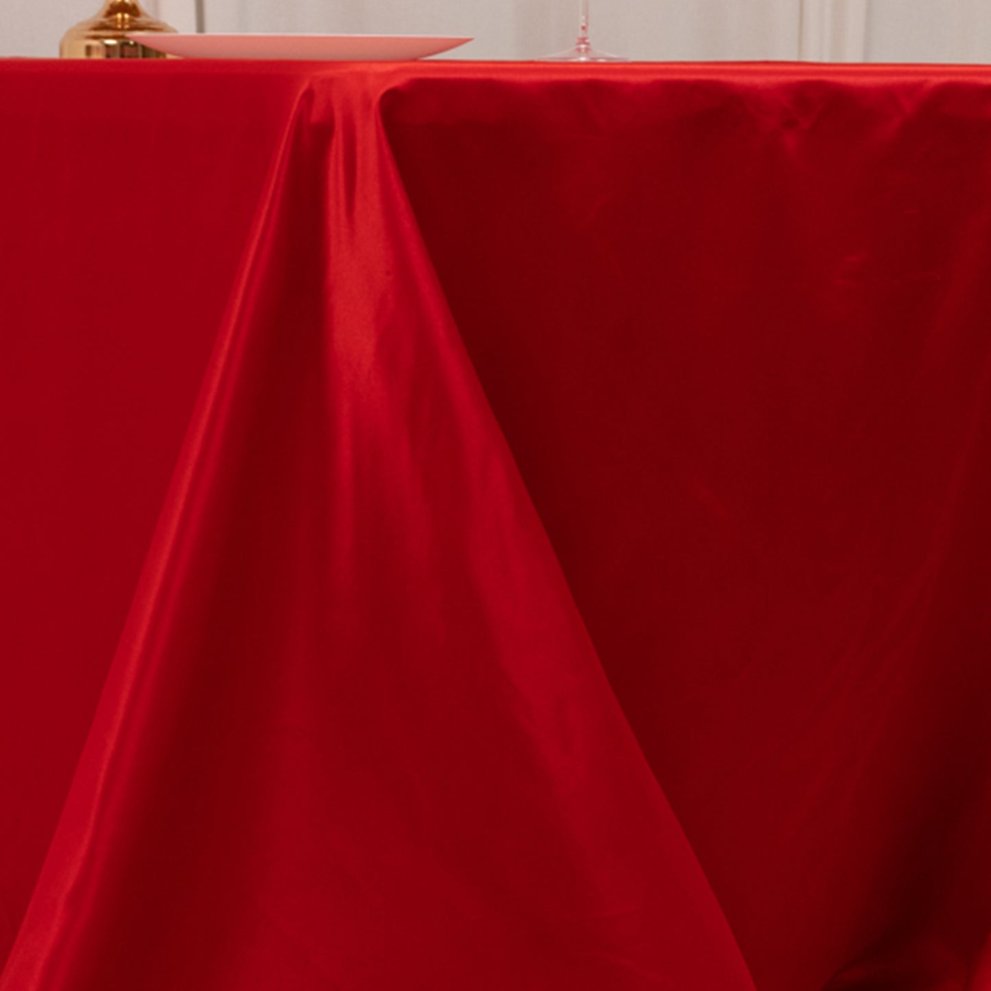 Red seamless satin tablecloth for a 6-foot table with floor-length drop.