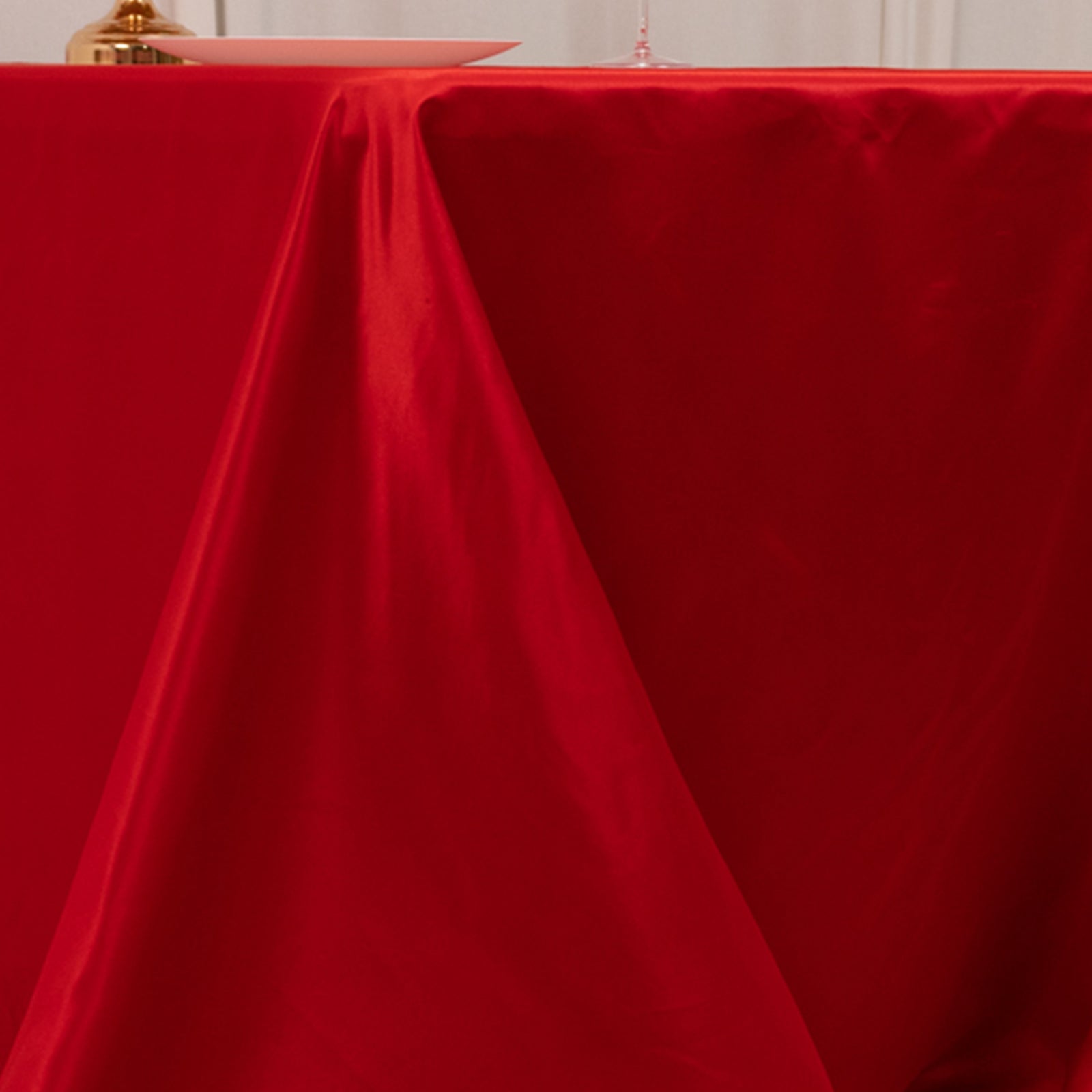 Red seamless satin tablecloth for a 6-foot table with floor-length drop.