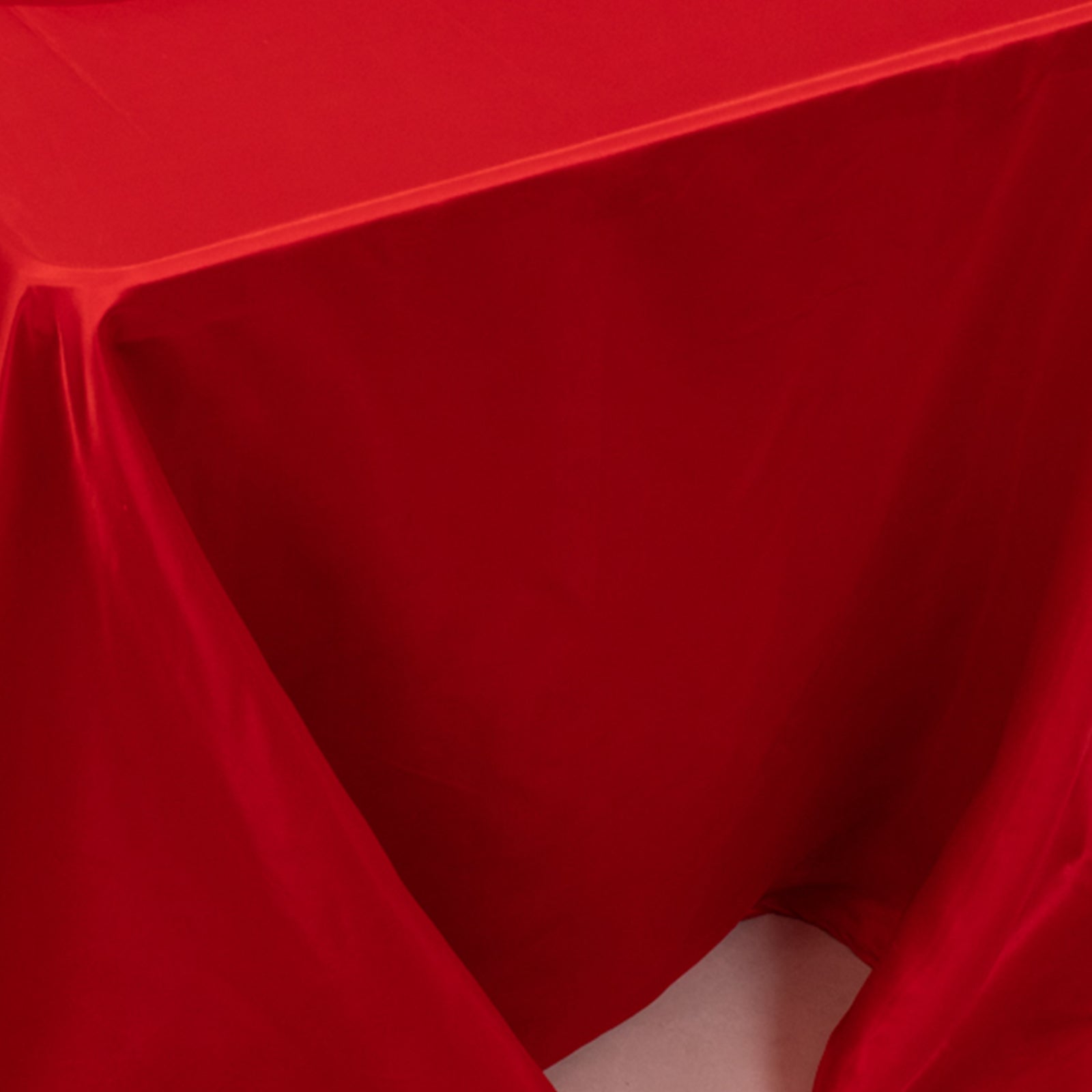 Red seamless satin tablecloth for a 6-foot table with a floor-length drop.