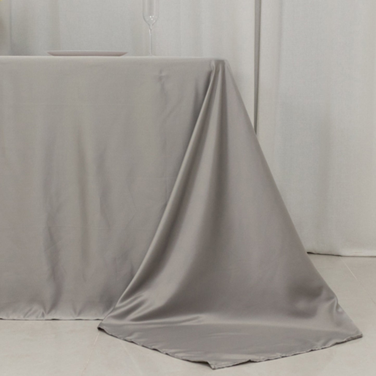 Silver satin tablecloth for 6-foot table with floor-length drop.