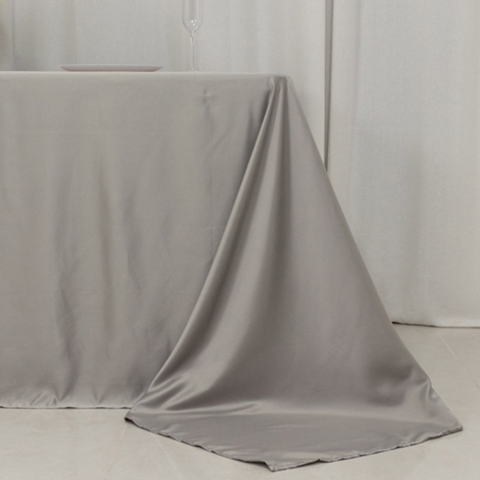 Silver satin tablecloth for 6-foot table with floor-length drop.