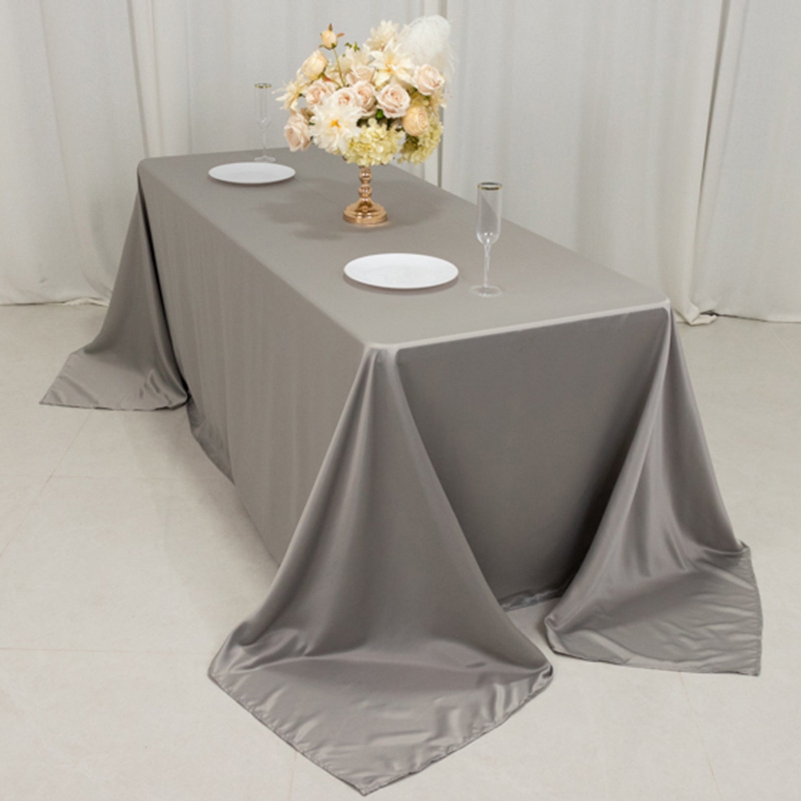 Silver seamless satin tablecloth for a 6-foot table with floor-length drop.