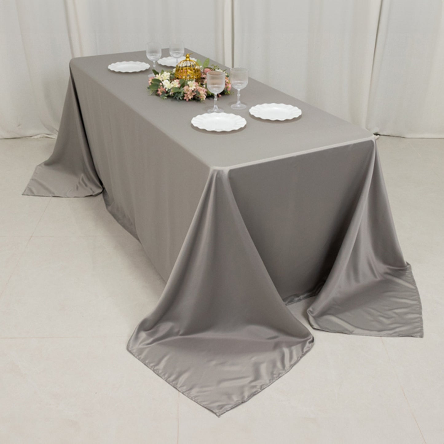 Silver seamless satin tablecloth on a 6-foot table with a floor-length drop.