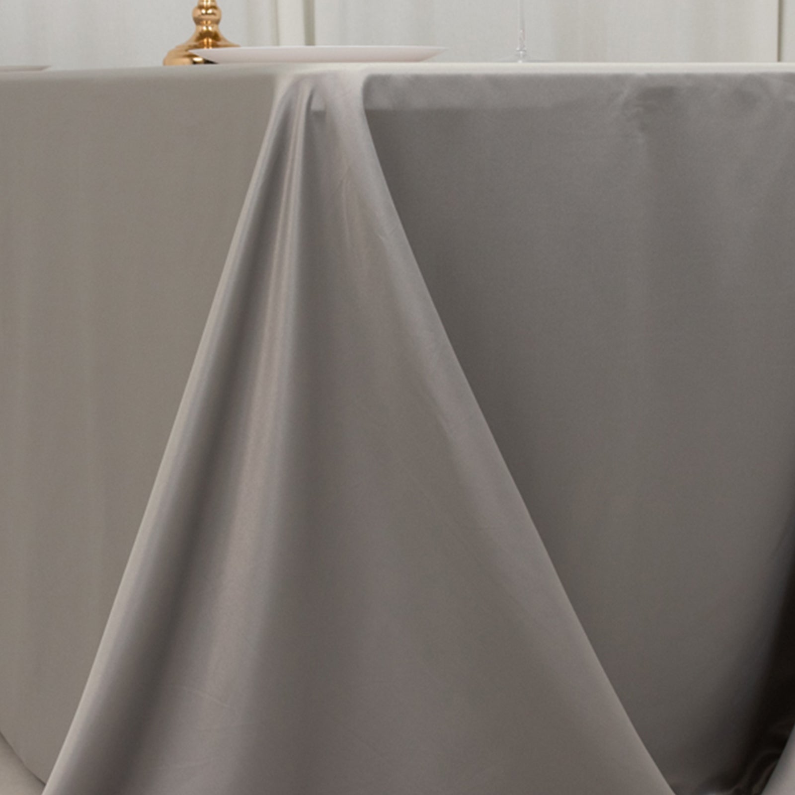 Silver satin tablecloth for 6-foot table with floor-length drop.