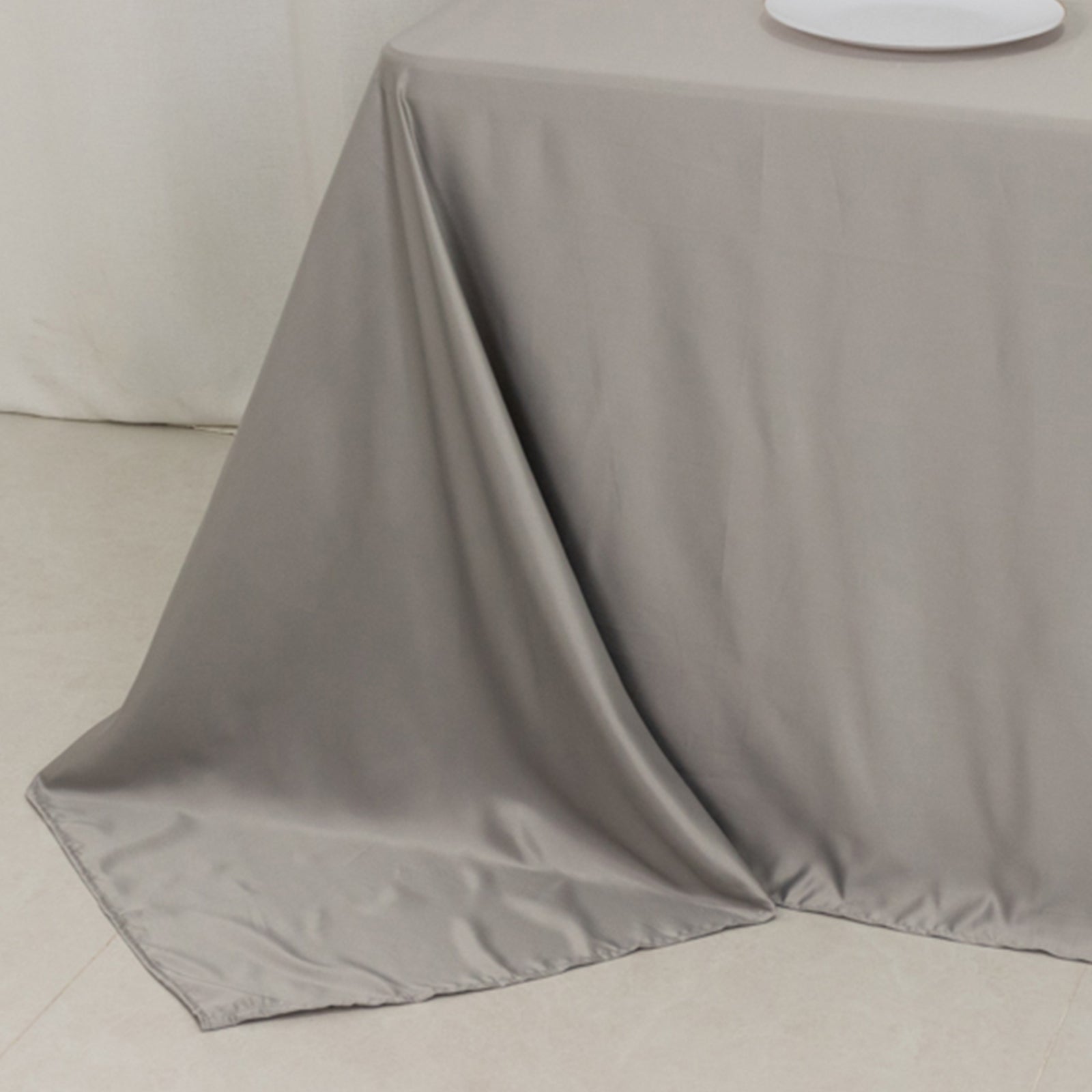 Silver satin tablecloth for 6-foot table with floor-length drop.